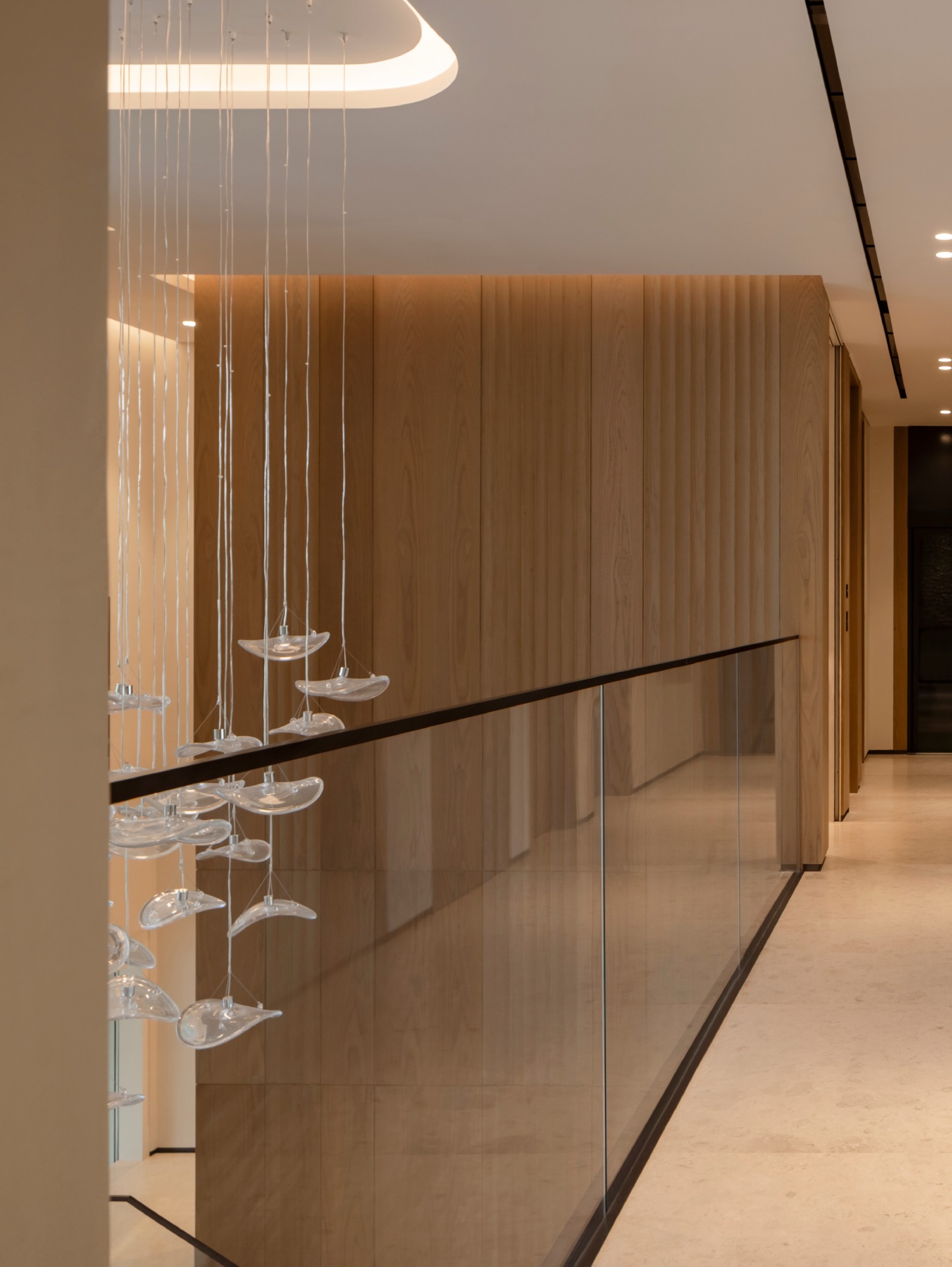 A floating staircase rises from a base of grey marble, illuminated by a soft LED under glow. Vertical fluted wall panels add texture and height, enhancing the double-volume. Above, cascading glass pendants shimmer like droplets of light.
Photographer: @toozestudio
#InteriorDesign #Design #Dubai #DubaiLifestyle #DubaiLife HighEnd Luxury LuxuryLife LuxuryInterior Awards DesignInspiration InteriorStyling Style Styling HomeInteriors InteriorDesignStudio HiglyCommended InteriorDetails DreamHome HomeDesign ModernHome InteriorForYou DesignGoals LivingRoomDecor TailorMade Bespoke Furniture DesignFurniture