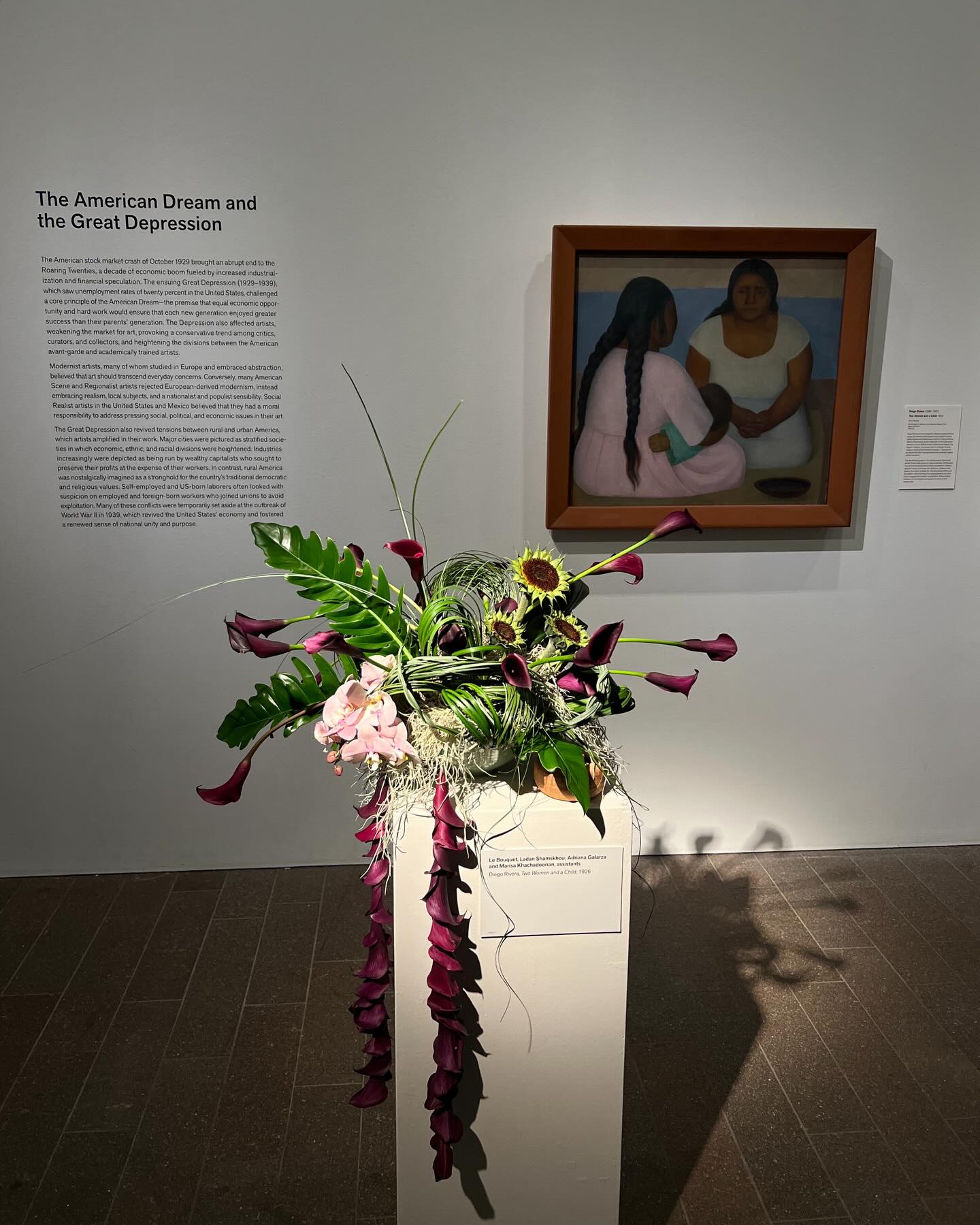 “Diego Rivera’s art was shaped by Mexican socialist politics and by the Mexican Renaissance, which sought to revive native cultures and traditions as a means of unifying national identity. Rivera drew artistic inspiration from his personal collection of over 59,000 ancient American art objects, the largest in Mexico. He housed them in a Mayan Revival museum whose portal held the inscription: ‘I give back to my people that which they can rescue from the artistic legacy of their ancestors.’”
“The two female figures in “Two Women and a Child” recall similar Olmec stone figures or Jalisco ceramics, which would have provided appropriate historical precedents for Rivera’s idealized visions of working-class Mexicans. Seated on the ground, the mother cradling her infant embodies fertility and procreation, while the empty food bowl adjacent to her companion suggests the need for nourishment. Rivera implies solidarity with his subjects by signing his name on their ceramic dish.”