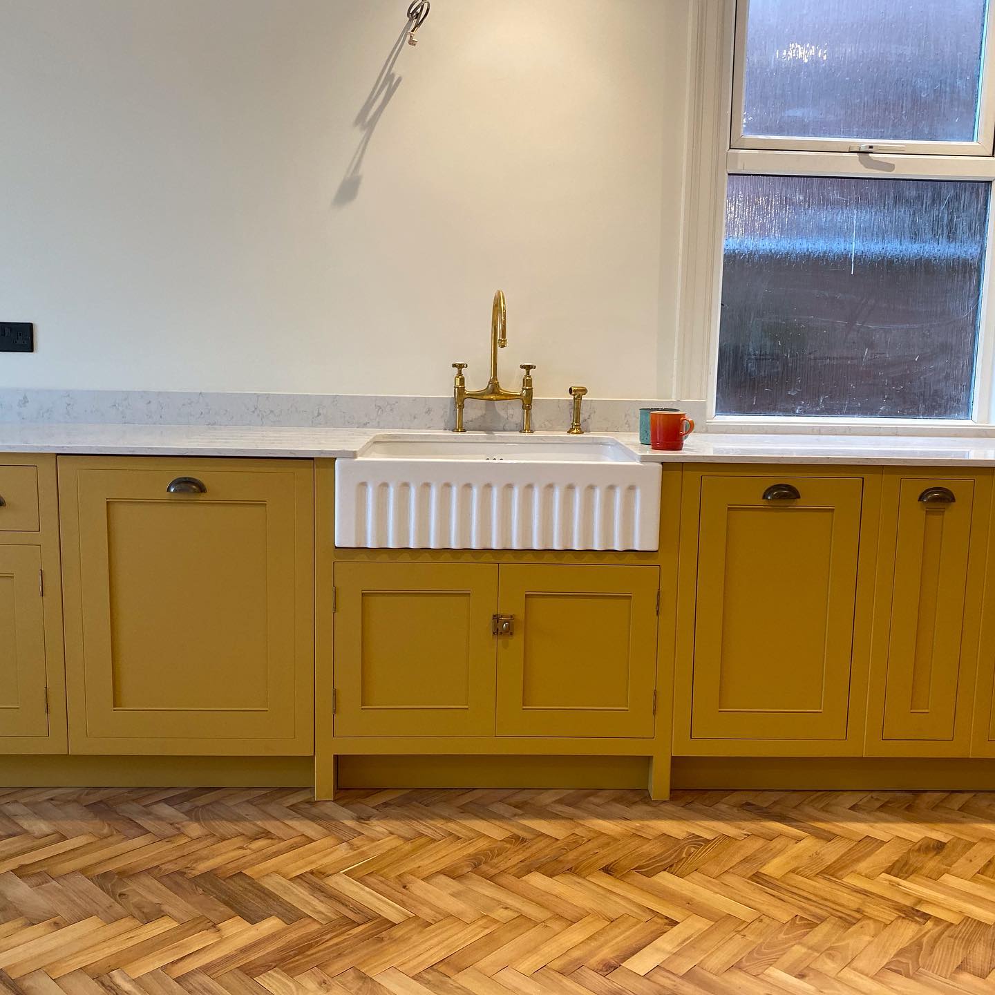 These customers knocked through to create a room thats open plan living at its best, perfectly light and airy making this stand out kitchen look like an art piece. Taking true ownership of everything on this kitchen from colour, to handles, sink and cupboard combinations this couple truly know how to design a beautiful kitchen. Tall bi-fold doors led out to the garden and warm wooden parquet flooring lay beautifully underfoot, a great mix of traditional and contemporary and a lovely place to call home. #jharriskitchen