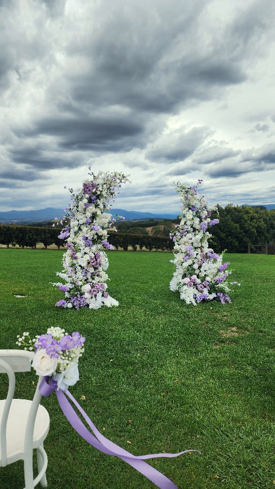 Vera and Nick’s wedding at Vines of the Yarra Valley was filled with soft lilac tones, candlelight and the most beautiful vineyard backdrop. Their ceremony was planned overlooking the rolling hills before the rain moved celebrations under the gazebo.
From the ceremony florals to the reception tables styled with delicate purple blooms, every detail felt calm, romantic and completely them.
Thank you Vera and Nick for trusting me with your flowers and styling. It was such a joy creating this for you at Vines of the Yarra Valley.
#Decodays #VinesOfTheYarraValley #YarraValleyWeddings #MelbourneWeddingStylist #ArtificialWeddingFlowers
Amazing photos coming up by
@singlesoulau
Celebrant @
If you’re planning your wedding, feel free to get in touch with your personal flower brief.
Decodays VinesOfTheYarraValley YarraValleyWeddings MelbourneWeddingStylist ArtificialWeddingFlowers
@decodays - custom designed hire florals, LED Candles, props, styling and concept. Feel free to send a DM