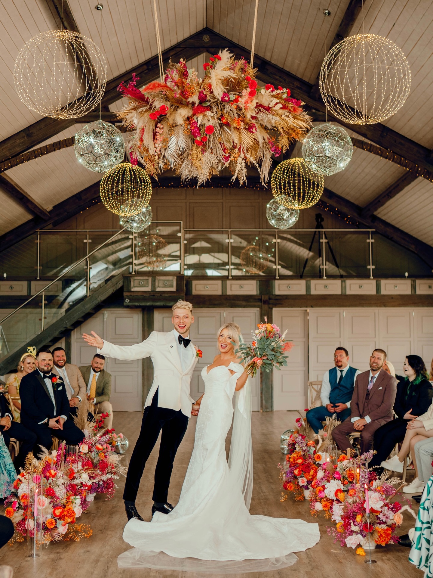 K& J ❤️🪩
What a day this was for the awesome K&J at
@yorkshireweddingbarn!
Bright faux, fresh, and dried florals for the aisle, meeting at the central point, where K&J took their vows right in the middle below a show stopper of a hanging installation.
Yorkshire Wedding Barn is always a pleasure to style, a blank canvas that can be transformed into your own vision, whether it be bright and vibrant, or soft and neutral. We’re there next month again for another gorgeous set up and we can’t wait!
Photography by the awesome @hamish.irvine 😍
#yorkshireweddingbarn #yorkshireweddingsuppliers #yorkshirestylistandflorist #colourfulwedding #barnweddingvenue