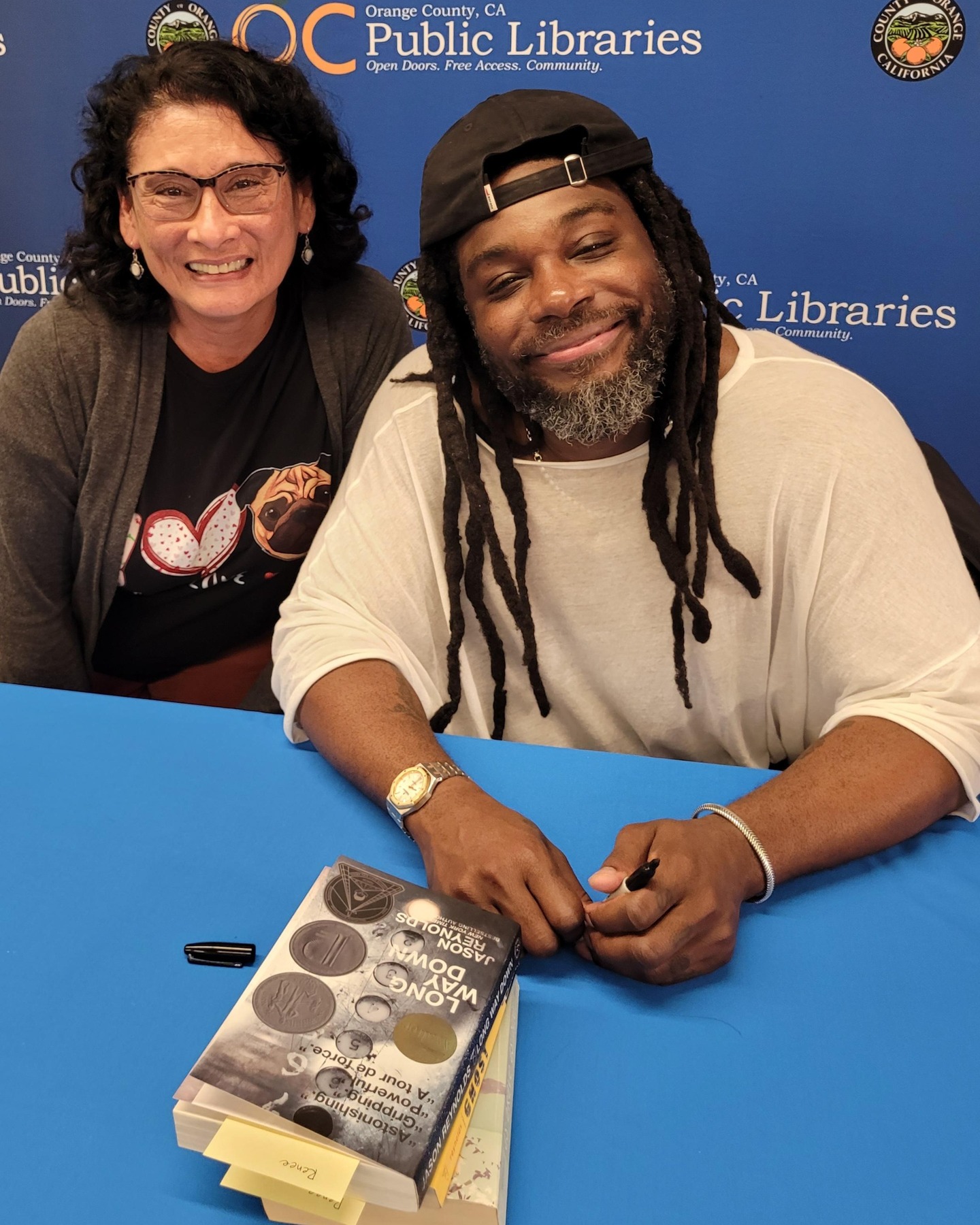 Author Jason Reynolds in my hometown!
⭐ Yesterday, I met Jason Reynolds at an author event hosted by the OC Library.
🙂 Yes! It was an absolute pleasure. I took notes, listening as Jason spoke about words and rhythm and the power of sound; layers of subtext as meaningful ideas that don't have to be shouted in the dialogue or paragraphs of his stories; and his passion for the heartbeat of language, his love of Shakespeare, and his fascination with all creatures living on the land or oceans of our earth.
🐶 I smiled wide when Jason shared envisioning his future with a dog. Whoo-hoo! That's when I couldn't help myself. My heart throbbed, my mouth went into overdrive, and I pitched -- as hard as any story I've written -- that Jason needed a pug or two. Sure, he wanted a big dog, a chill dog, and that's when I said pugs have big heads, a big belly, and a huge personality. They are sweet and cuddly and the perfect companion to warm your heart and soul. He asked about my two pugs, Anakin and Amidala, both pug mixes. One a pug Boston-terrier (lots of energy) and one a pug-yorkie (chill and snuggly).
📝Jason smiled as he signed three of his books (one a complimentary gift, the other two I had towed with me to the event). He didn't make any promises but he said pugs are all right with him.
😎 "I'll keep watch," I said. And that's when I knew. There could be a future story in his portfolio about a pouty, curly-haired girl named Renee and her two lovable pugs.
#authorsigning
#bookevent
#libraryfun
#storytelling
#writerslife
#booklover
#readmorebooks
#alwaysreading