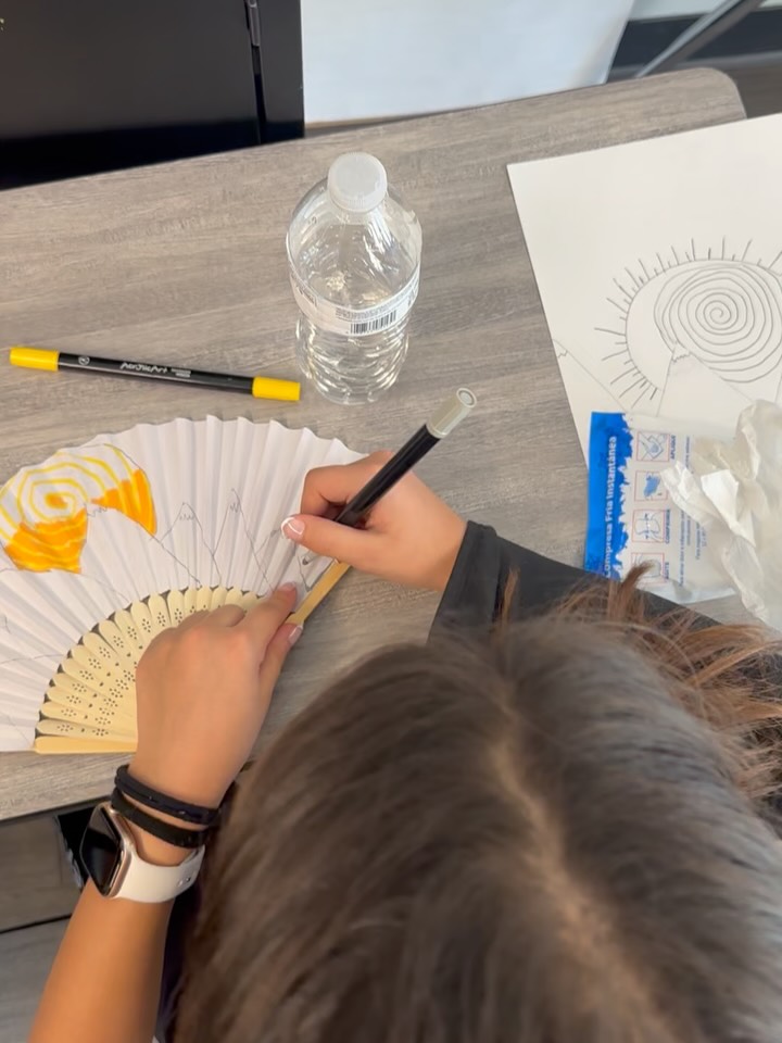 The Indian Dance group is making fan props for their Spring recital.