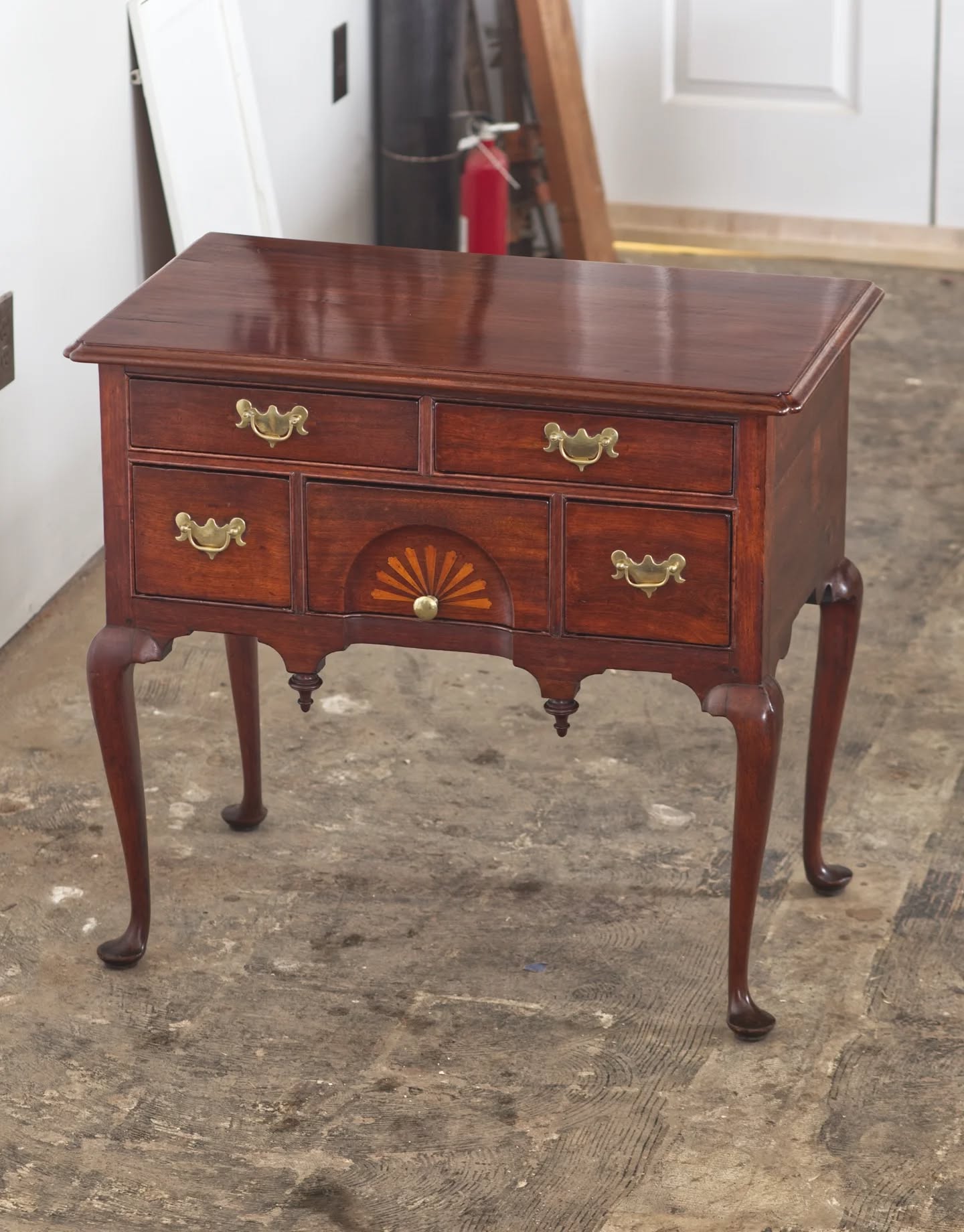Two kinds of objects that infrequently come through the studio are Queen Anne furniture and furniture from New England. This walnut (possibly butternut) lowboy ticks both of those boxes.
The lowboy was in to address the bleached out top that was also damaged by a cleaner recommended by an antique dealer. Some color work and a little French polish on the top plus a little waxing is all it needed.
A comparable was found in my reference books: the lower case of a mid-18th century Massachusetts highboy (Downs, Joseph. American Furniture: Queen Anne and Chippendale Periods, 1725-1788). The same pattern on the skirt and the drawer sides have the double arch moulding on the top edge (photo 3).
#furniturerestoration #furniturerestorer #lowboy #massachusettsfurniture #restoredinbaltimore