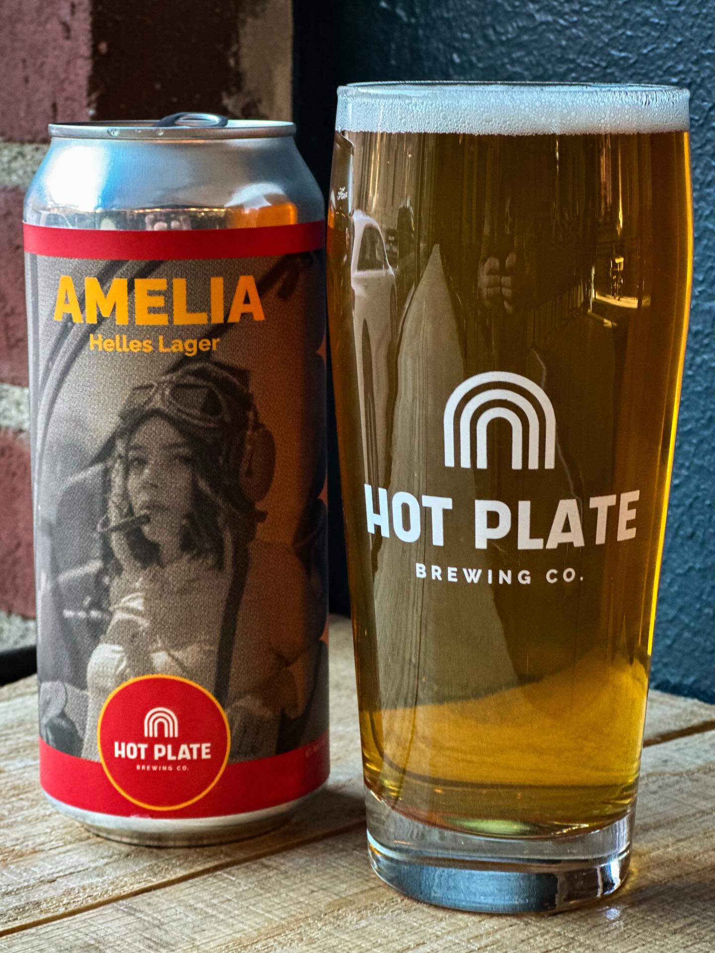 🚨🍻✈️ New beer alert!
Today, we’re tapping Amelia, our Helles Lager, which we’re bringing back after a pretty long hiatus.
Sarah first wrote this recipe when we were still homebrewing on a hot plate—it was one of the last ones we actually made on a hot plate, and it was her first “transatlantic” lager, which is why we named it in honor of Amelia Earhart.
The label art for the 4-packs (which are also available in the taproom starting today) are a nod to the colors found on Amelia’s plane.
Crisp and malt-forward, this true-to-style Helles lager is one of the beers we’re most proud of. Swing by the taproom and give it a try!