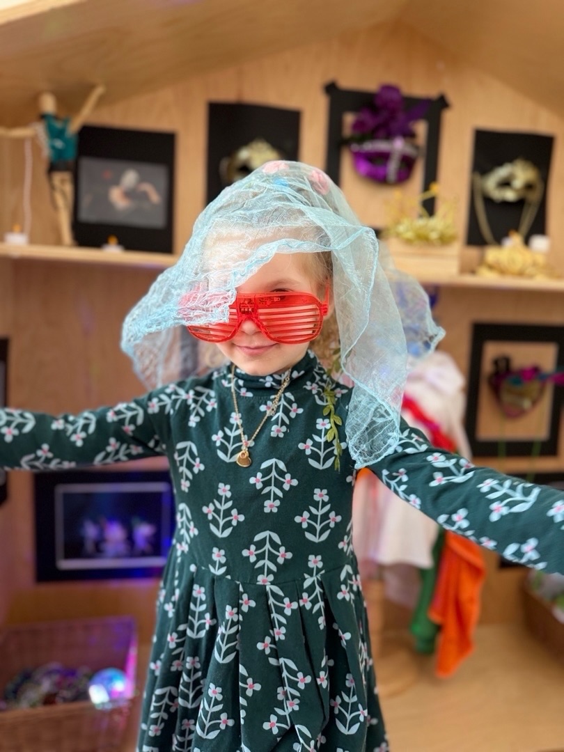 Our classrooms were a flurry of costumes and crowns as children stepped fully into their heroic roles. In dramatic play, centers transformed into bustling bakeries where little hands rolled, filled, and shaped hamantashen to share with friends. There was joy and creativity in every corner.
In early childhood, learning happens best through the body and the senses. Children don’t simply listen to a story, they become part of it. The holiday of Purim invites exactly this kind of whole-child experience. When we hear Haman’s name during the Megillah, we don’t just talk about standing up to negativity, we shake our graggers and actively drown it out. When we feel happiness, we don’t just name it, we deliver mishloach manot, give tzedakah, and bring that joy into someone else’s home.
This is the power of early childhood education. We understand that meaning is built through doing. When children mix, bake, dress up, give, shake, and celebrate, the experience becomes part of who they are, not just something they heard about.
Purim reminds us that the most powerful lessons are not only spoken, they are lived. And when we give children opportunities to experience joy, generosity, courage, and community with their whole selves, those impressions last far longer