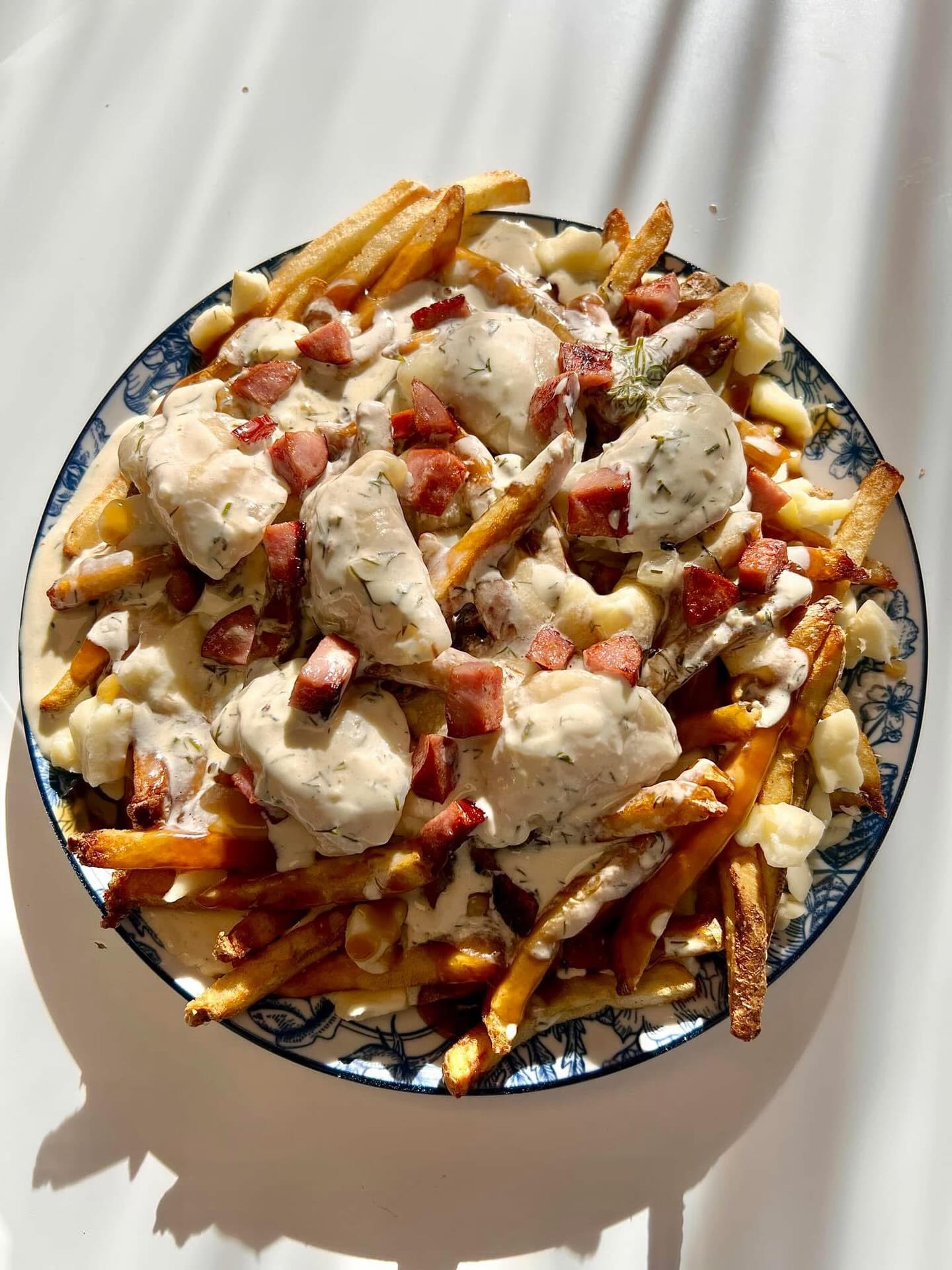 After many years and lots of tears (yes we heard you!) the Ukrainian Poutine is back... and it’s huge!!
Hand cut fries, gravy & cheese curds
6 potato cheese perogies in our creamy dill sauce and fried kubasa on top
Stacked into a plate that is borderline unreasonable in size.
Available:
Lunch - dine in or takeout
Supper - takeout only
$18
Pre-order on take out is HIGHLY recommended!