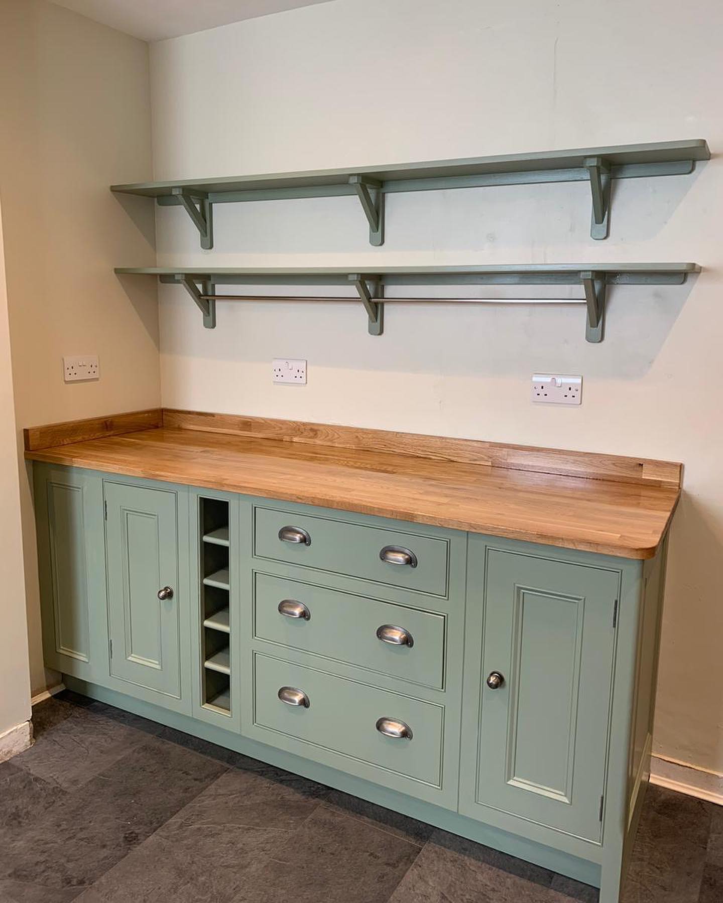 Just the basics in this room, but the basics done so right! Humble cupboards, a good rich oak topping the furniture and a sturdy natural stone on the floor. Did we mention the wine rack perfectly fitted within the unit!?...#handmade #bespoke #kitchens #farrowandball