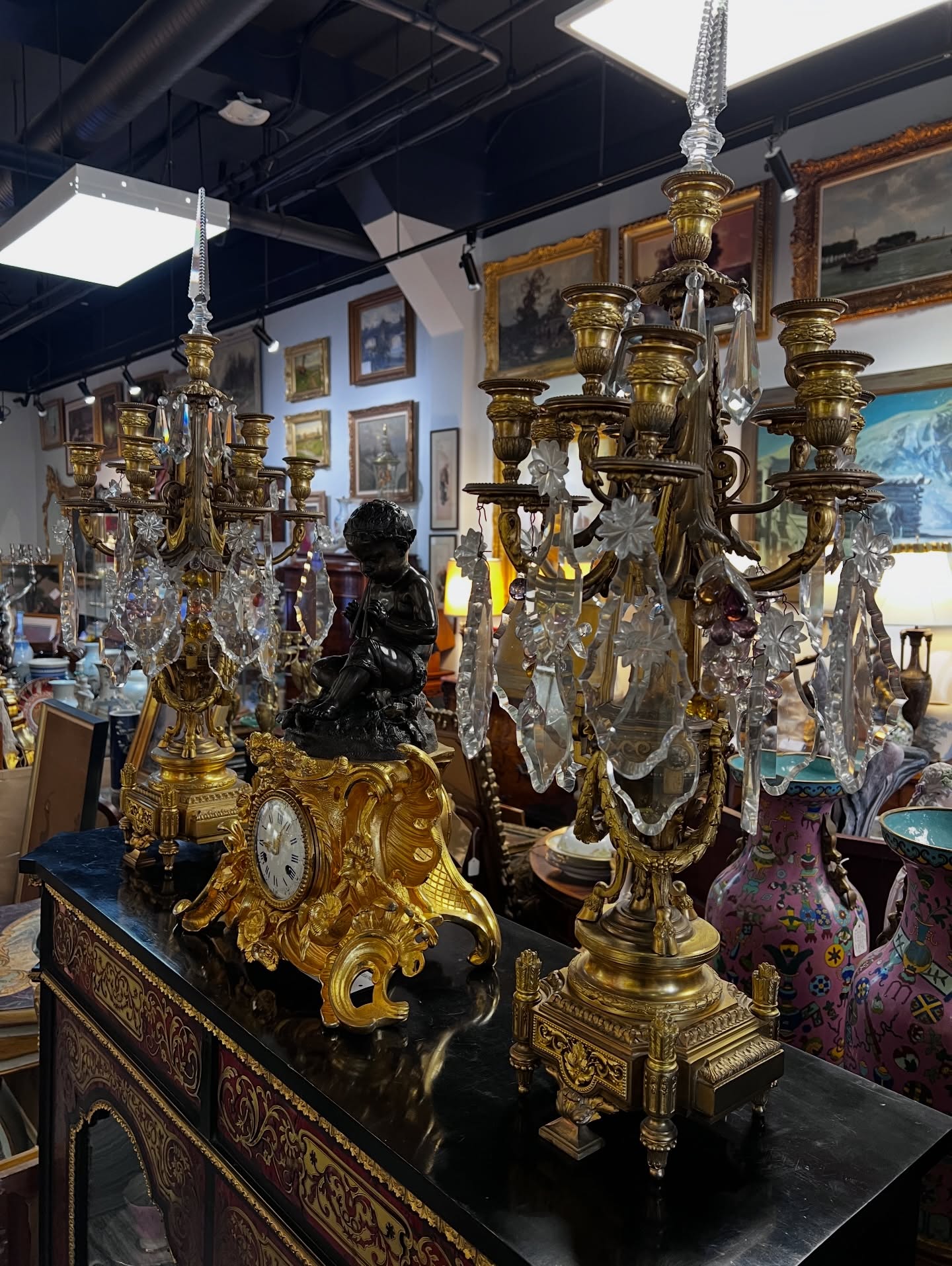 A moment of old-world glamour in Dundarave ✨
This striking 19th-century French gilt bronze clock topped with a cherub sits between a magnificent pair of crystal-draped candelabra, each arm hung with faceted prisms that shimmer beautifully in the light. Pieces like these once illuminated grand European salons — both practical and theatrical.
I love when the shop feels like this… layers of paintings, crystal, bronze, and history all in one view.
Antiques have a way of transforming a room instantly.
📍 Martine Boré Antiques – Dundarave, West Vancouver
#martineboreantiques #dundarave #frenchantiques #giltbronze #antiquecandelabra antiqueclock antiquedecor westvancouver vintageinteriors antiquelovers timelessinteriors