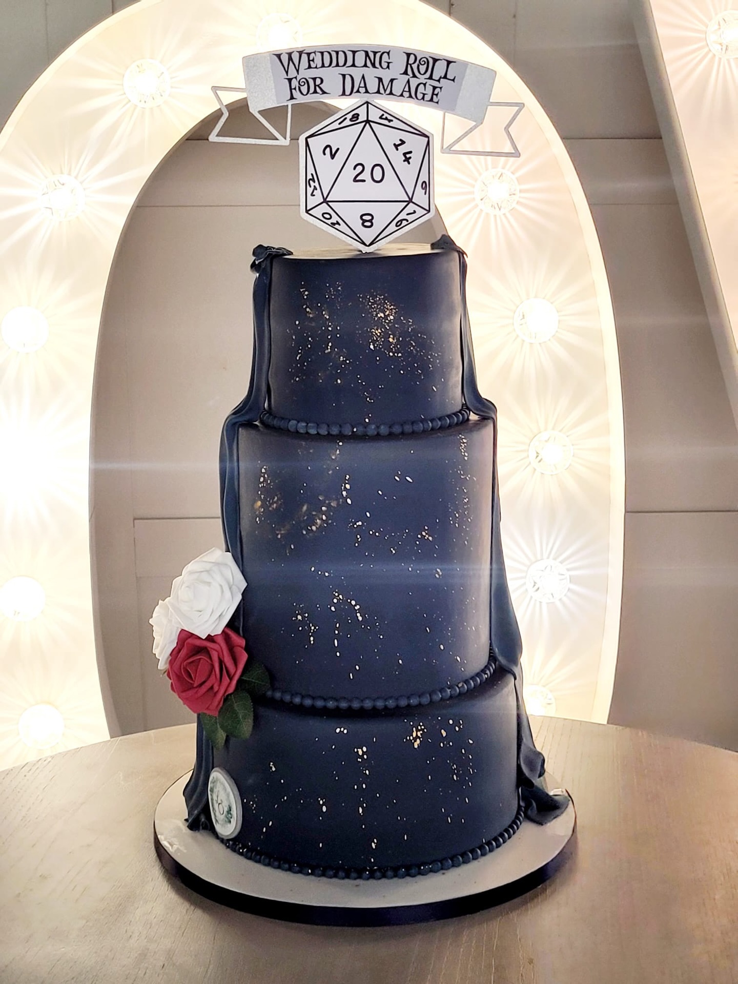 Not your typical wedding cake… 🖤💛 It’s a monster 😈 Slide to reveal 👀
A custom three-tier wedding cake designed for a couple who love a little adventure and a lot of fun. Finished in deep navy with subtle gold splatter, draped fondant detailing, and roses — topped with a playful “Wedding Roll for Damage” D20 to bring their love of tabletop gaming into their big day.
This wedding cake was designed to celebrate a love for creativity, craftsmanship and a bit of adventure. From the rugged wood-effect tier and monster teeth, to the bold DeWalt-inspired toolbox base, every detail was built to reflect the brides & groom’s passion while still keeping a striking wedding centrepiece.
Topped with a personalised Dungeons & Dragons–style topper and finished with the couple’s initials, this cake proves wedding cakes don’t have to follow the rules - they just have to tell your story.
Would you go bold like this for your wedding cake? 👀👇
#WeddingCake #BespokeCake #LuxuryWeddingCake #ThemedWeddingCake #dungeonsanddragons