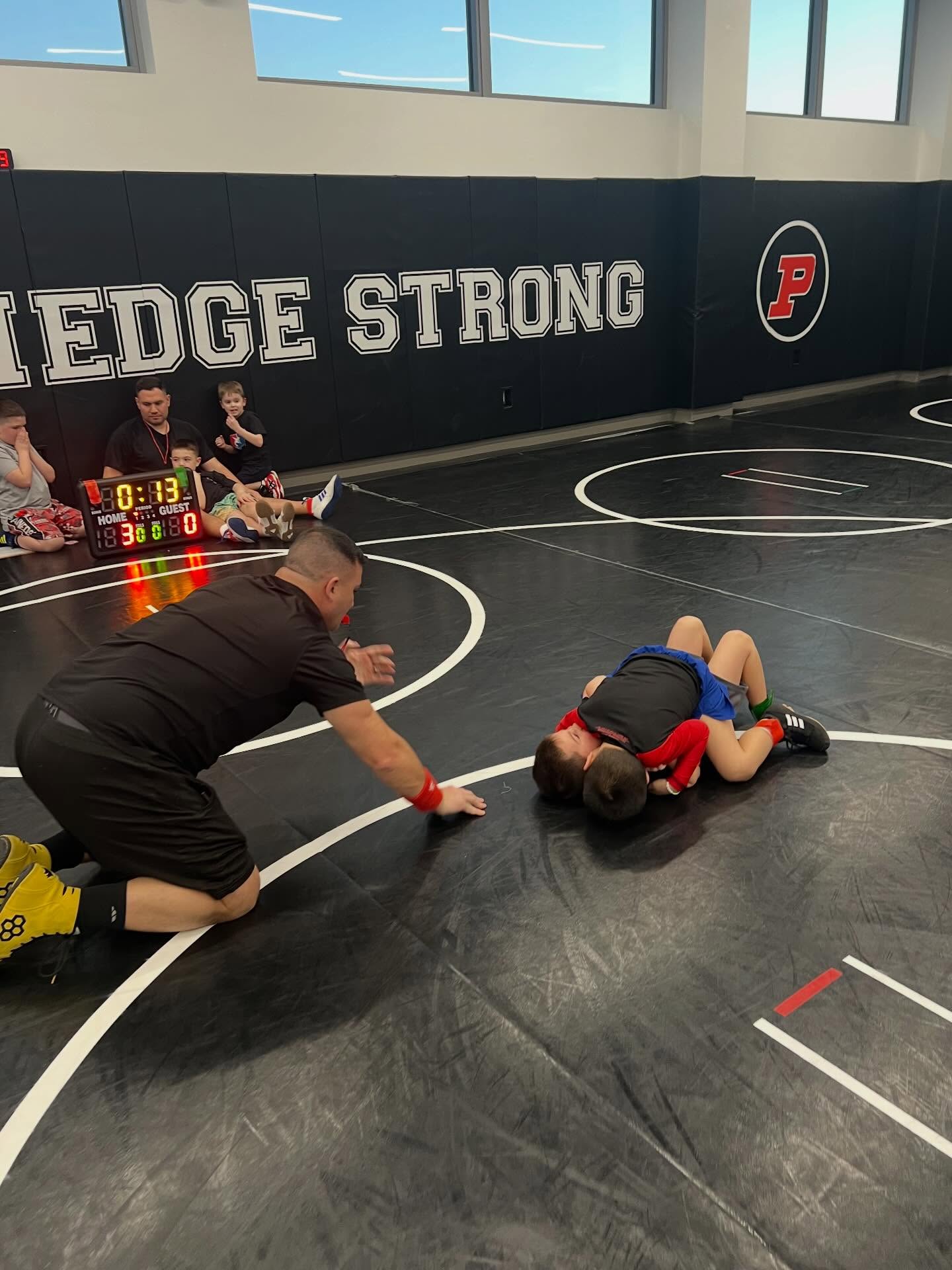 Our youngest athletes got their first real taste of wrestling a full match in the room. With the scoreboard running and Coach Mike reffing, the kids stepped onto the mat one by one and experienced what it feels like to compete. For many of them, it was the very first time wrestling a full match, and they did an incredible job.
The coaches couldn’t be more proud. It takes courage for a young wrestler to step on the mat, shake hands, and give their best effort. Win or lose, every one of these kids showed bravery, effort, and a willingness to learn. That’s what this sport is all about.
This was a big step in their wrestling journey, and it was awesome to see the smiles, the determination, and the support they gave each other. The future of the program is bright.
Great job, wrestlers — the coaches are proud of all of you!