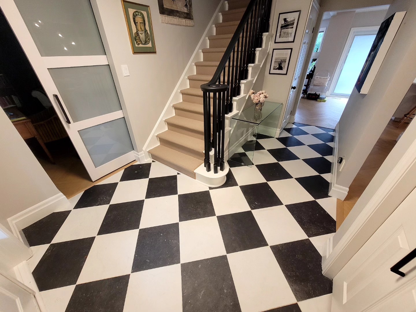Large format black and white tiles in a diamond pattern. Check the last picture to see the tile before. Great choice by the customer.
Custom made oak transition strips were installed where the hardwood and the tile meet.
All tiling, hardwood, trimwork, and painting done by maximus craftsmanship.