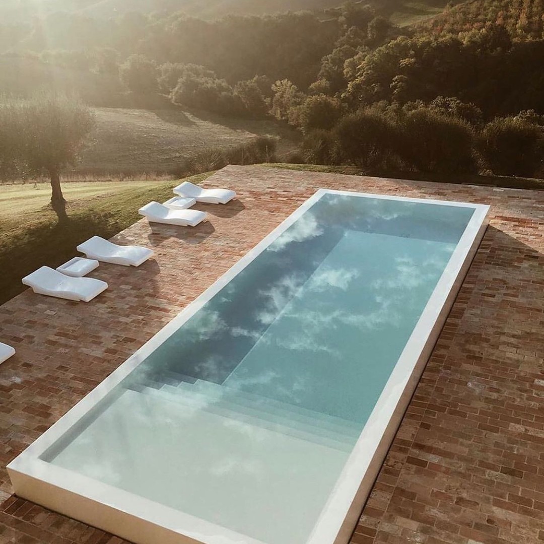 Brick paving is often associated with more traditional projects, but when used with a restrained material palette and clean lines, it brings warmth to modern projects. The earthy red tones juxtaposed against the bluish green water creates a harmonious blend of complimentary colors.
#swomagazine #wespidemeuronromeoarchitects #wespidemeuron #scobarchitectureandlandscape #terradominicatahotel #parkhotelmondschein #thestylemate #archdaily #mesuraarchitecture #dezeen