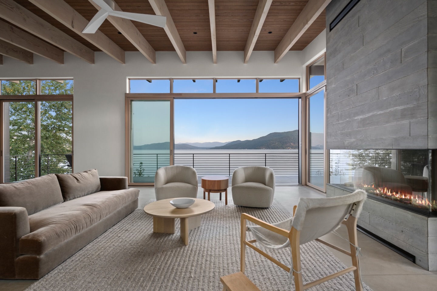 The interior reveal.
Stepping inside this Modern Waterfront Residence, the connection to the landscape becomes even more apparent. Expansive glass walls frame the lake from nearly every angle, while warm wood beams, skylights, and natural materials bring softness and texture to the modern structure. The open living spaces were carefully built to balance scale and comfort, creating rooms that feel both expansive and inviting.
From the kitchen’s clean, integrated cabinetry to the living area that opens directly toward the water, every element was executed with precision to support the architectural vision and the way the home will be lived in every day.
Built by Ramey Construction
Architecture by Uptic Studios
Spaces like these remind us how powerful thoughtful design and careful craftsmanship can be when they come together.
#RameyConstruction #ModernWaterfrontResidence #NorthwestModern #LuxuryHome #CustomHomeBuilder