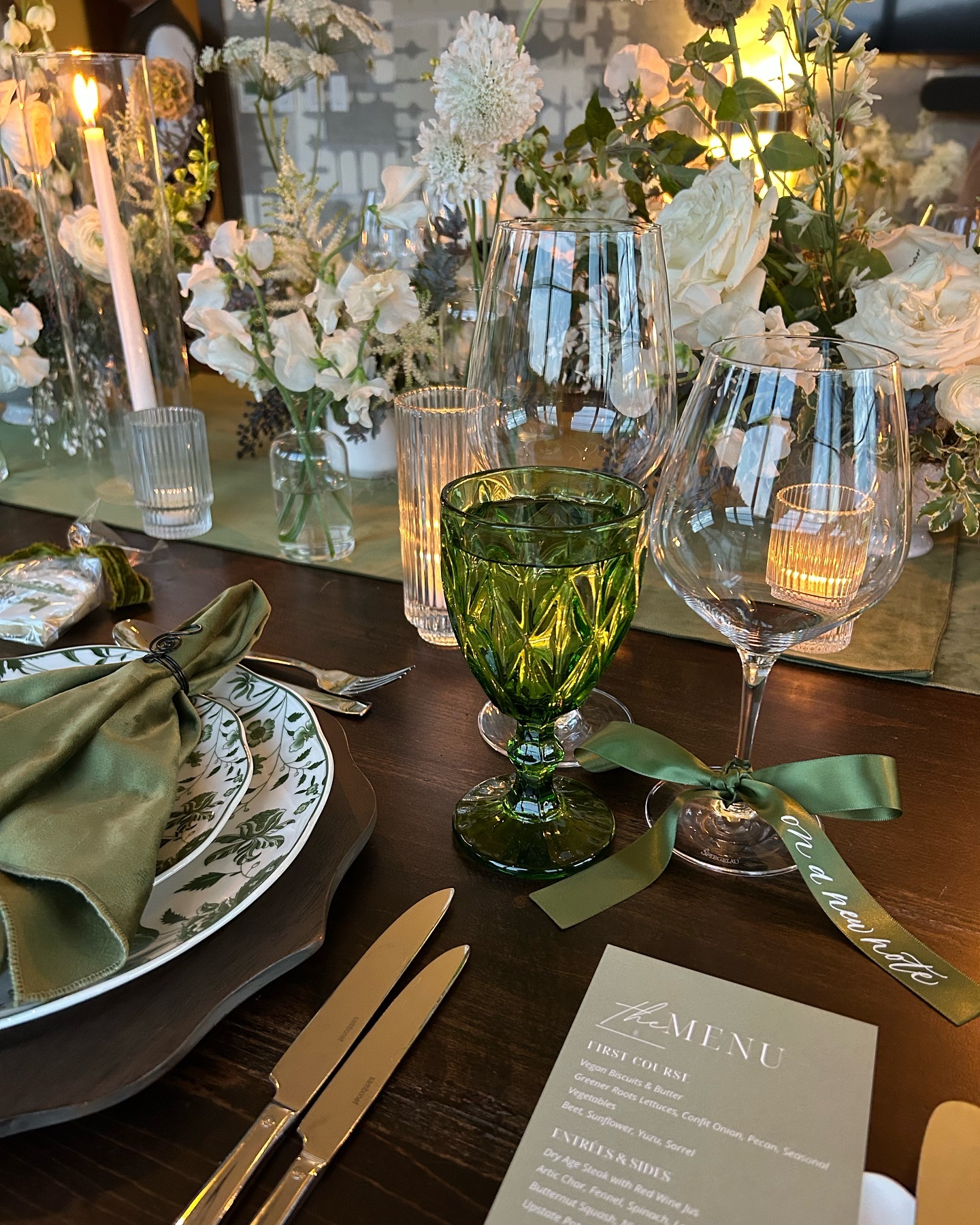 Our client hosted this intimate dinner party to celebrate her daughter’s change in careers after being in the music industry for over a decade. We discussed many potential themes, but the one we settled on was “On A New Note” 🎶
A couple ways we incorporated the theme were:
- Custom satin ribbon tied on each wine glass with “on a new note” handwritten on each one.
- Musical note napkin rings.
- Handmade sugar cookies at each place setting for the guests to take home reading “Congratulations Emily” with a hand drawn musical note.
- Custom menus to match the invitations which also included each guest’s name as a place card.
- An acoustic guitarist playing music as the guests arrived.
This was a fun one! 🎶✨