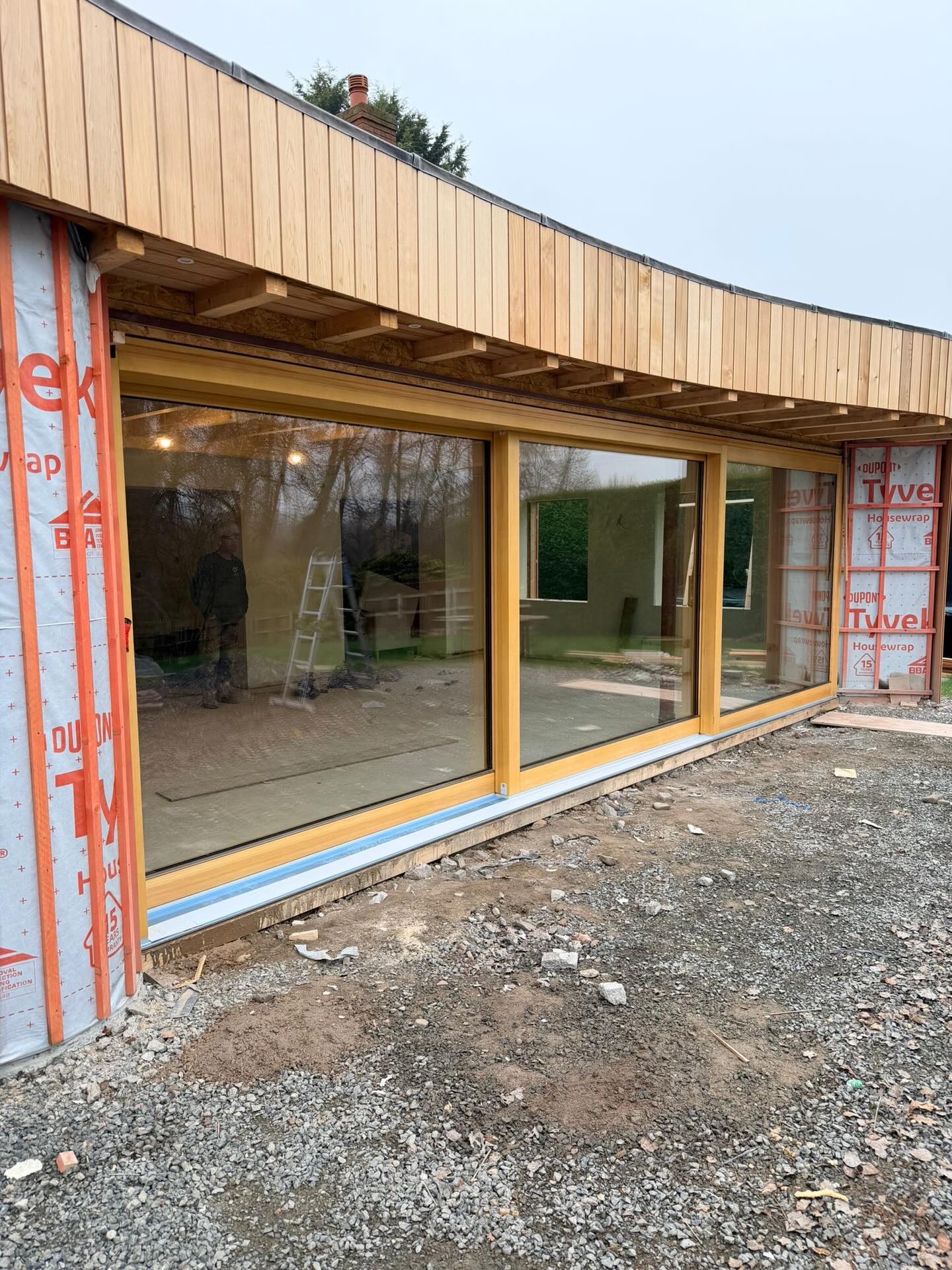 Progress images from a site using a mixture of our aluclad windows and timber HS sliding doors. Each HS door includes a lift and slide mechanism to help you slide huge areas of glass much more easily and is factory finished to a stain/paint of your choice. Looking great already