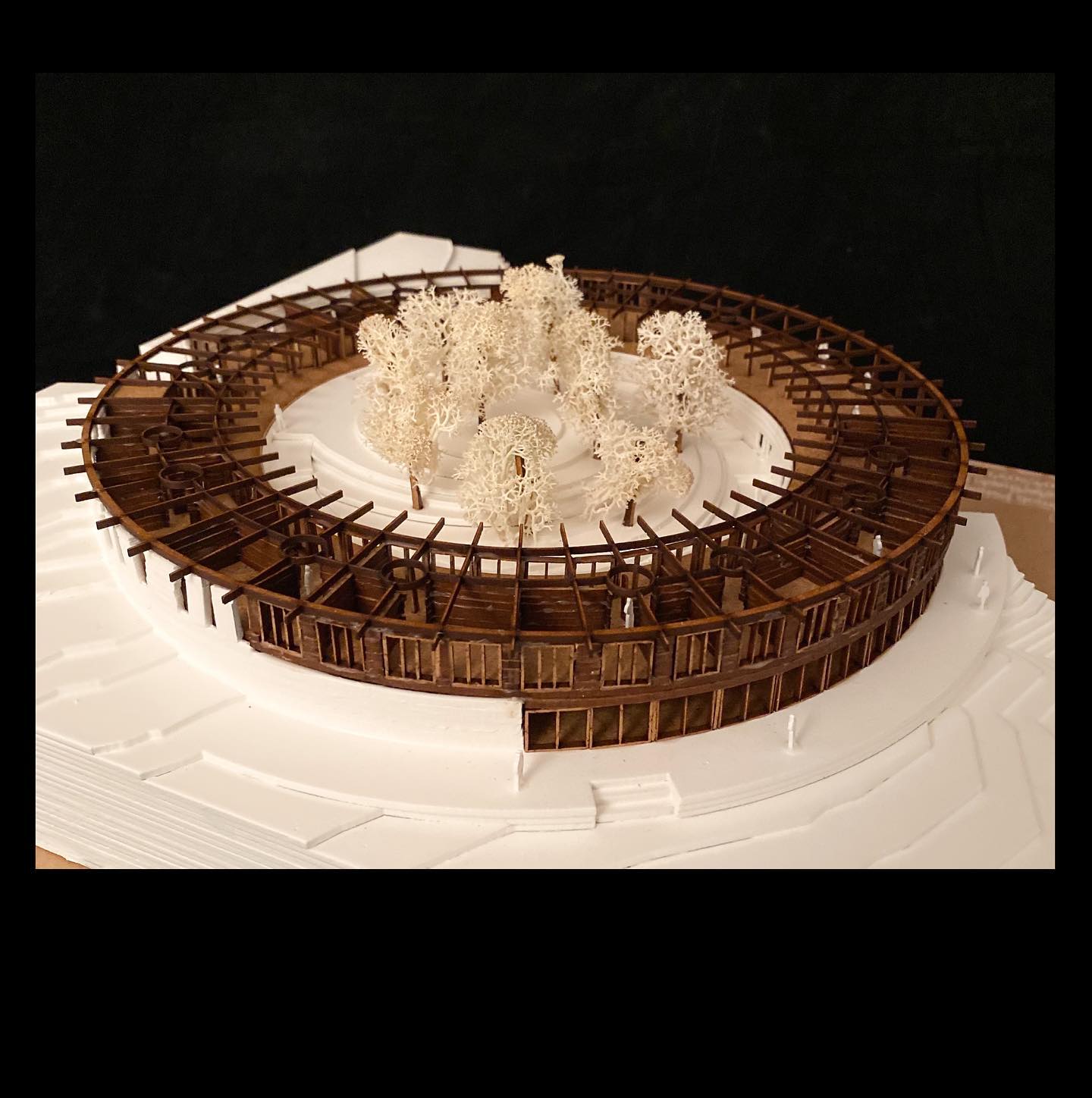 Project 3
Eco Hotel Catalonia
Named after the Tavertet living Catalonian philosopher, Raimon Panikkar (1918-2010). The Raimon Panikkar Hotel design follows this philosophers ideas around the interconnection between nature and humanity, rather than commercially exploiting the site with a human-centric, solely view-oriented volume. The hotel places nature at its center and raises environmental awareness among visitors.
Built with local granite and wood/clt in a strict 3m grid alone, the construction is completely prefabricated in elements; lowering construction effort and environmental impact.
The granite walls carve out of the mountain and are topped with a light wooden construction that reflects the surrounding nature where the trees grow out of the cliffs. A site visit showed a natural spectacle, defining the genius loci.
Due to the climatic conditions of the Pre-Pyrenees in combination with the Panta de Sau, intense morning fog develops.
A low-tech design with fog collectors and solar chimneys can harvest the fog and create natural ventilation. The naturally collected water and the solar panels on the roof allow the hotel to function primarily self-sufficient.
Beneficial impact on the local community, the hotel creates jobs for regional employees. Guests can stay for a few hours or several weeks and enjoy the local cuisine, relax in the spa, visit workshops for sustainable tourism and species protection, and above all reconnect with nature.
#architecture #architect #architecturemodel #architectural #maquettearchitecture #lasercutting #masterthesis #circle #bestnewarchitects #modelarchitecture #potd #new #realestate #design #designhotel #larsenliverpool #architecturecompetition #woodarchitecture #ecofriendly #newpost #architecturelovers #studentwork #archiporn #archigram #hotel #newartist #arquitectura #arch #discover #architecture_hunter