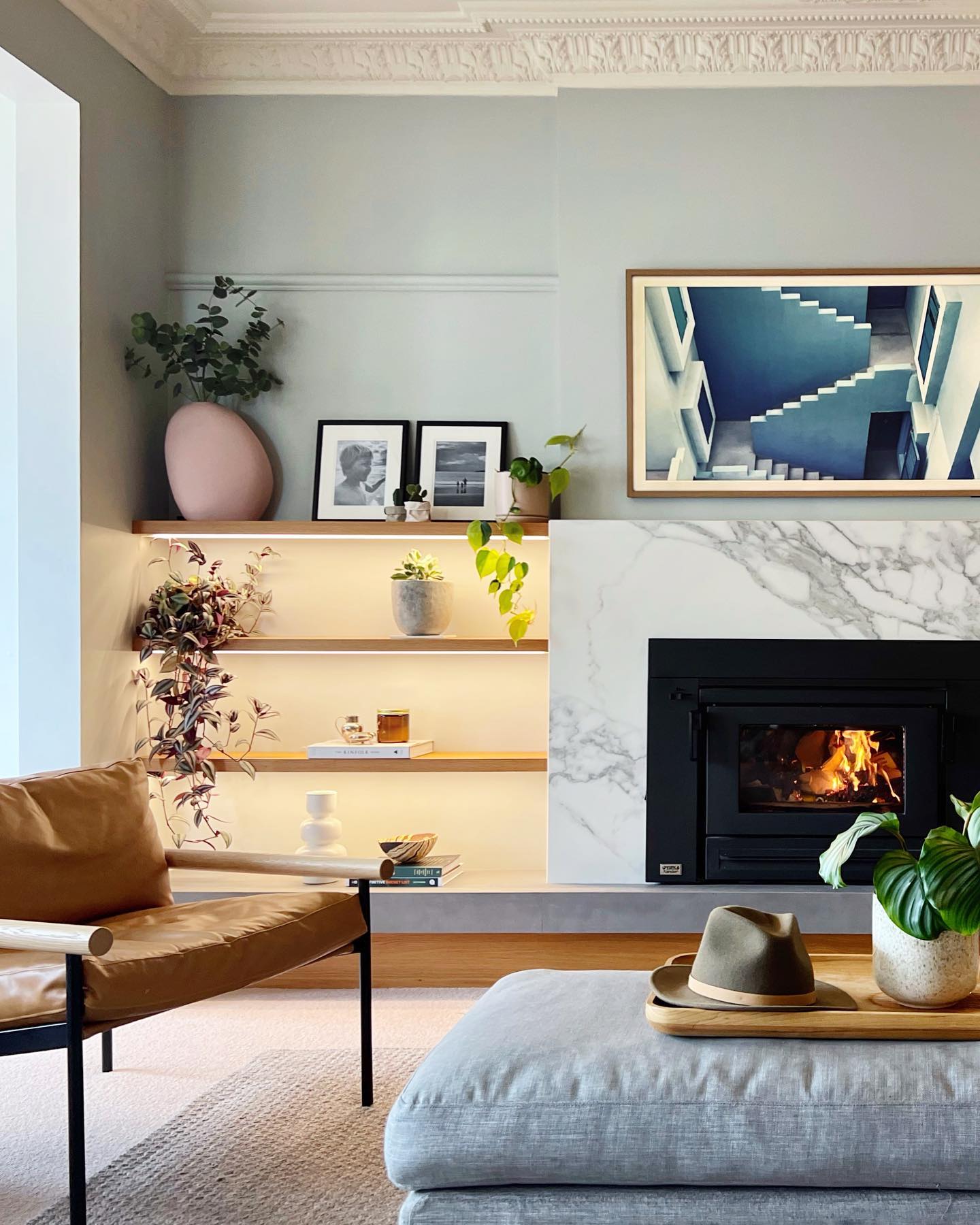 We injected new life into this living space by creating a much needed focal point (see before shots at the end)
The @yuncagroup Xander fire was selected for both its good looks & excellent heat output🔥
A contemporary spin on the design with a porcelain surround, raised hearth and timber shelving has made this family fall back in love with their home.
BTW - If you’re looking to change up your wall colour #Dulux Spanish Olive 1/2 is a refreshing deviation from good old white.