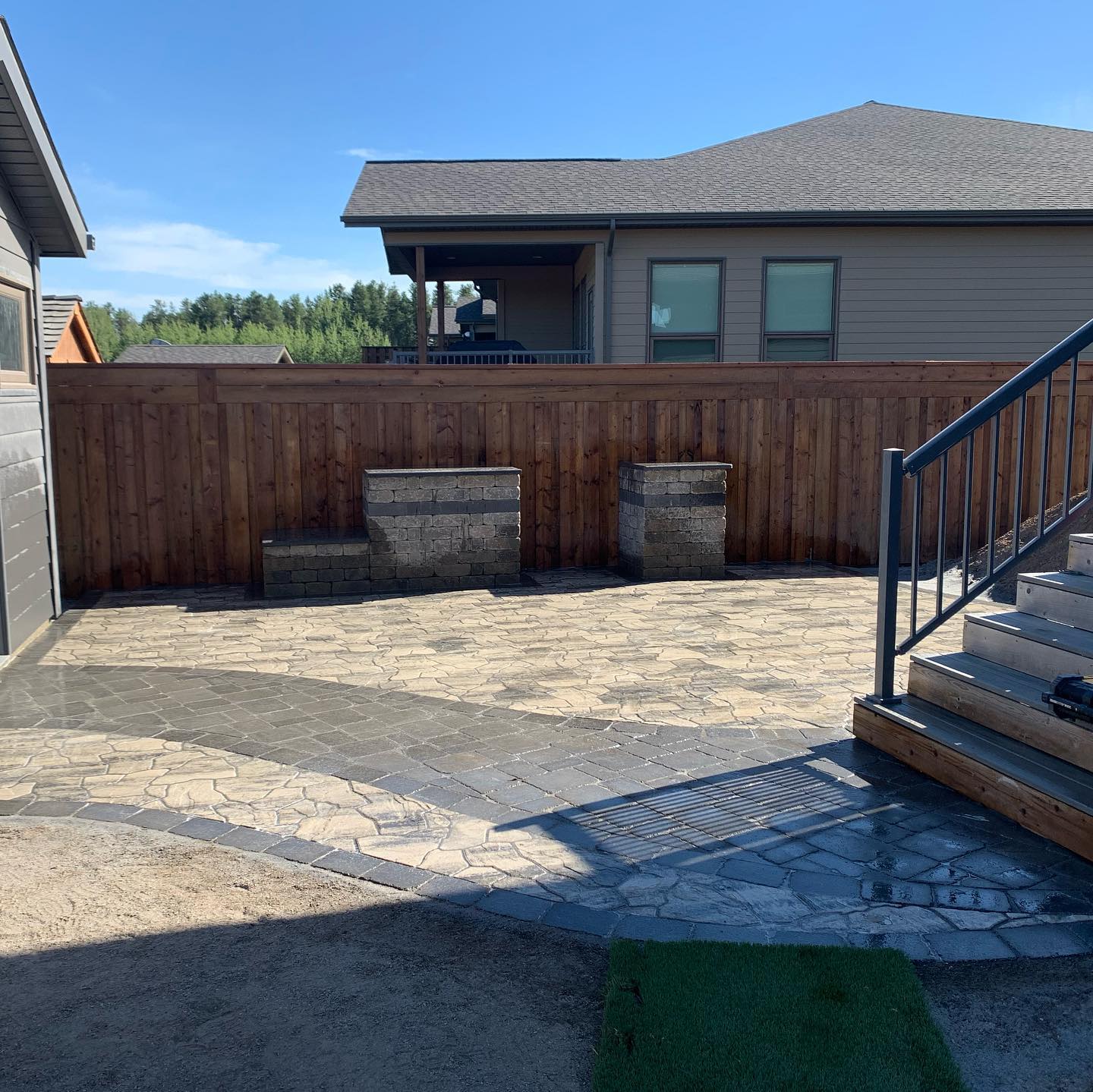One part of this project is complete and ready for the long weekend. We used mesa flagstone for the patio, with a Roman paver inset walkway and boarder. The @barkmanconcrete kitchen kits are perfect for your outdoor cooking and hosting. #backyardoasis#outdoorcooking#curvypatio#curbappealmatters#curbappeal