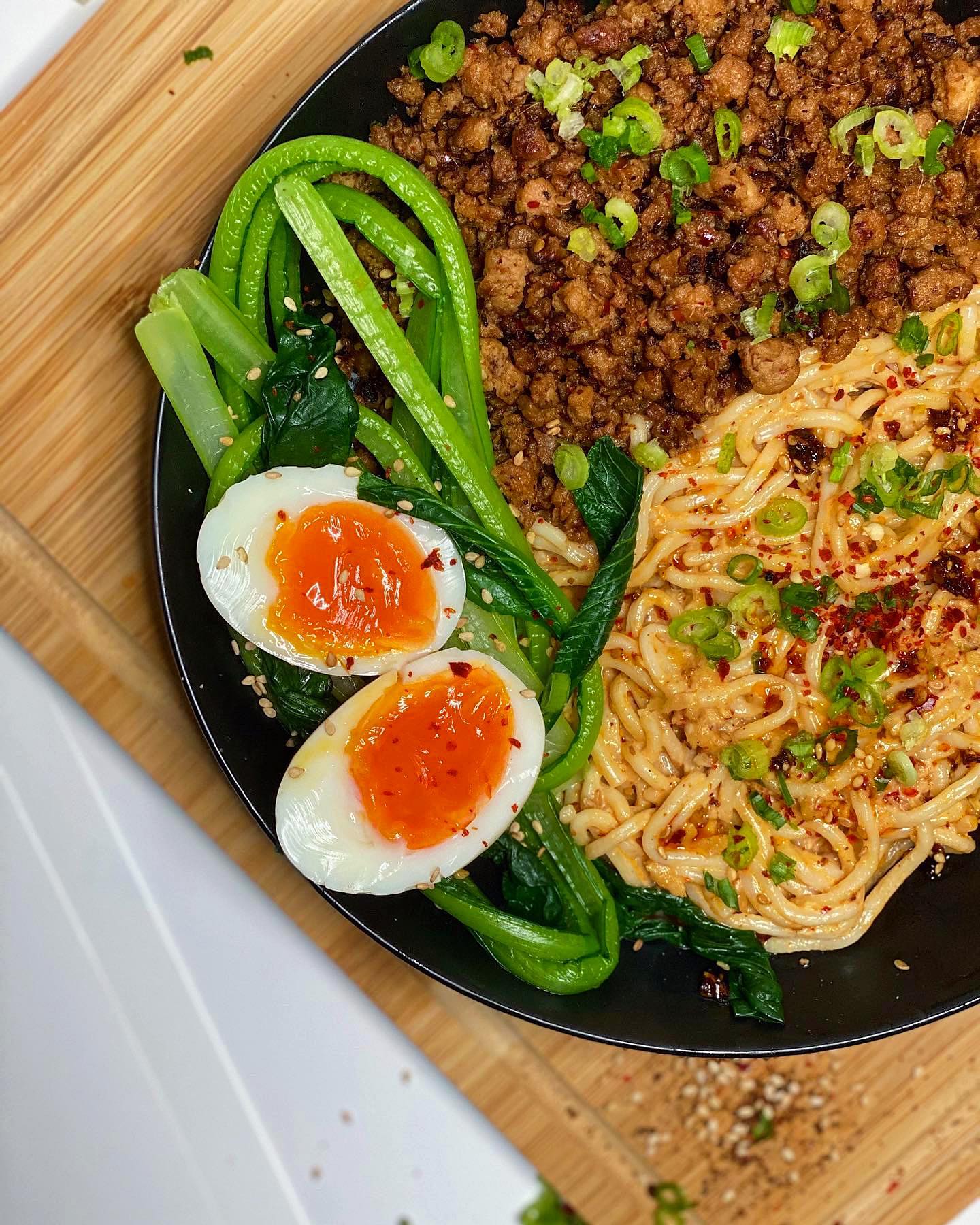 JP Take on Dan Dan Noodles 🍝
———————————
This dish is definitely for those who love spice. In my version, I made a light sauce to mix with the noodles to give it a base layer. I added some pork mince, choy sum and a half boiled egg, before garnishing it with loads of chilli oil.
—————————
1. Marinade 1 packet of pork mince in 1 tbsp grounded pepper, 1 tbsp sesame oil, 1 tbsp soy sauce, 1 tbsp rice vinegar, 1 tbsp minced ginger and 1 tbsp garlic. Once combined set aside.
2. Next, prepare the sauce by mixing in a bowl: 80g tahini, 4 tbsp water, 1 tbsp garlic, 2 tbsp soy sauce, 2 tbsp ginger, 2 tbsp chilli oil, 2 tbsp honey, 1 tbsp sesame oil and 1 tbsp rice vinegar.
3. Next, boil your ramen noodles as per the instructions on the packet and drain. Now, place back over the heat and mix in 2 tbsp of the prepared sauce.
4. Cook your pork mince until the meat is browned and is broken up.
5. In some boiling water add the choy sum and let it wilt for only 20 -30 seconds and remove.
6. Now, half boil an egg by adding an egg to boiling water and leaving it for 6 mins.
7. Begin to assemble your dish with some of the sauce at the bottom, followed by a layer of noodles, topped with the pork mince, choy sum and halved eggs.
8. Finally garnish with some spring onions, crushed peanuts and chillis, before adding some more chilli oil.
————————————
#chinese #dandannoodles #instafood #instagood #foodporn #foodblog #spicy #fyp #pork #noodles #ramen #egg #chopsum #britainsbesthomecooks_ #chilli #yummy #recipe #stayhome #homecook #oriental #foodporn #instadaily