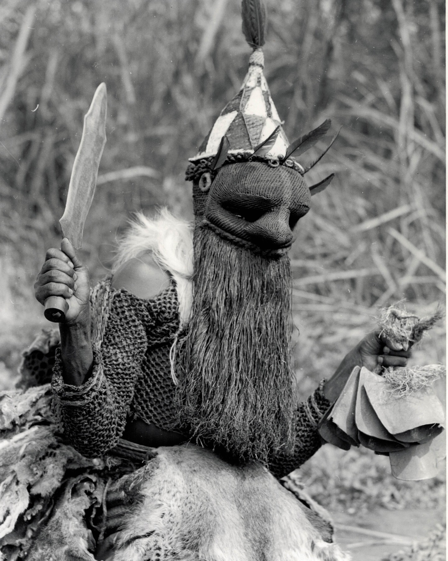 Lieven Storme vintage African photography and tribal art.
Picture of the day #133
Heart4Darkness offers a collection of over 5,000 original vintage photographs that illuminate the rich cultural history and heritage of the African continent. All photographs have been assessed for authenticity, artistic quality, and condition of preservation and are unmounted or disbound unless explicitly stated otherwise.
Photographer: Lamote, Carlo (1928-2017).
Title: untitled (Danseur Basala Mpasu).
Date: 1958.
Country: DR Congo.
Medium: unmounted gelatin silver print.
Size: 24,1 x 18,3 cm.
Condition: very good.
Reference: CLVI0314/1.
Provenance: Coll. André Vanhecke, The African Connection, Varsenare (B).
Extra: typed note with identification in French and Dutch on verso.
Congopresse: 31.406/45.
Man of the Basala Mpasu (Salampasu) The Basala Mpasu (Salampasu, meaning grasshopper wings) are named for the tattoos in the shape of grasshopper wings that adorn their foreheads. The Basala Mpasu are found west of the Lulua River.
Location: Mukasa.
Territory: Louiza.
Province: KasaĂŻ (current name = KasaĂŻ-Central).
Photographer and cameraman Carlo Lamote (1928-2017)) left for Congo in 1950 to work for the colonial information service. For ten years, he travelled to every corner of the Congo, Rwanda and Burundi to highlight the colonial achievements. Propaganda is the name of the game, but he turned out to be an excellent photographer. Together with his colleague Henri Goldstein, Lamote has shaped our image of the Belgian Congo. Open any book about the 1950s in the colony and you will find their names under the photos.After independence, he set up his own film production company and news agency, with Visnew, ABC and CBS as regular customers. He was also the founder of Congovox, the news service of the Congolese state broadcaster.