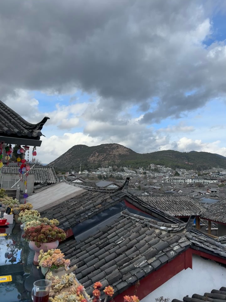 Fly back West into Yunnan Province and town of Lijiang.
The centre is a unesco world heritage site. A cobble-stoned, wooden framed delight. All canals, doorways and lanterns. It does feel a bit unreal as mostly tourist shops and inns but a fine place to get lost. Or perch on a rooftop cafe and watch it all unfold beneath as the masses came out after the rain.
Plus, unexpectedly cold requiring me to wear most of my wardrobe in eclectic layers.
Lots of tourists like to play dress up. Hiring Naxi costume, getting their hair and make up done then go out for a photoshoot.
Local delicacy is rice noodle soup where you add your own ingredients. Insects optional