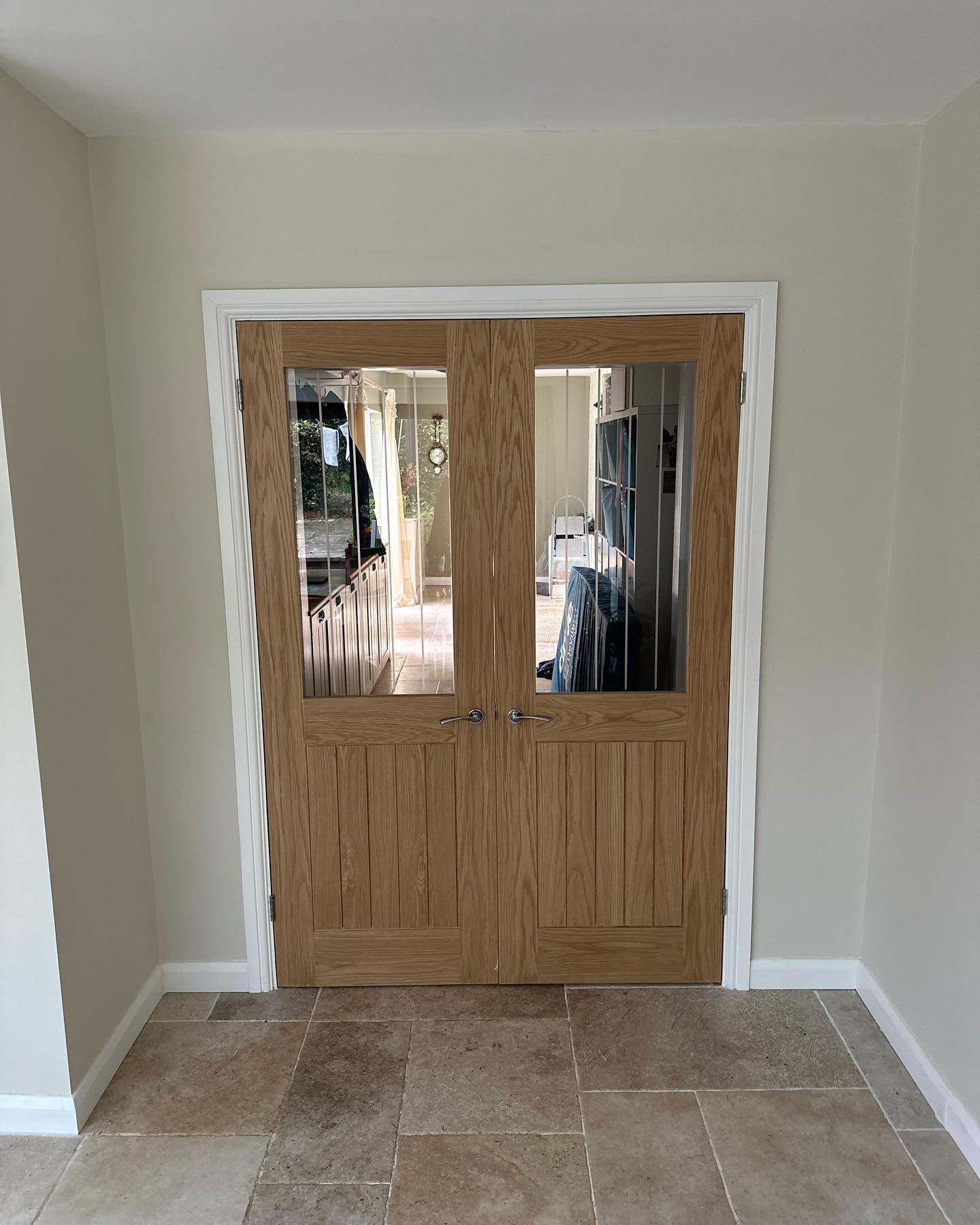Glazed doors recently installed, with a barn rail used for the doors leading into the living room!