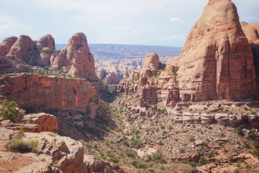 Hayduke Trail Day 3 || Moab to Pritchett Canyon (Behind the Rocks)
Ever since the creators of the Hayduke announced the route almost 20 years ago, many hikers have explored and shared alternate routes to visit nearby areas. I'll be taking several of them, usually whichever seem like a more scenic option. I already switched up the route on Day 1 to include the Devil's Garden area, for example, which was a suggested alternate on Andrew Skurka's Hayduke resources. Today I explored the Behind The Rocks Wilderness Study Area west of Moab, which is one of the many variants listed as part of Jamal Green's incredible Across Utah project.
The area features a rolling maze of rounded rock fins, and it's a wonder Jamal was able to find a route through it at all. Although I got a late start out of town, I quickly passed a group of Jeep overlanders on the way up to the area, and then was on my own. Really on my own. Finally, after navigating through hours of trail-less 1mph terrain, I ate dinner at a murky pool below a pour off and then finally rejoined some more jeep roads. Although they warned of highly technical terrain (modified vehicles and experienced drivers only!), they felt like absolute highways after what I had been trekking through.
A couple more hours of fast evening hiking brought me past features like Ostrich Rock and some distant arches, and then I easily found a flat spot to cowboy camp. This trip is going to be hard, but it's sure pretty.
#thruhike