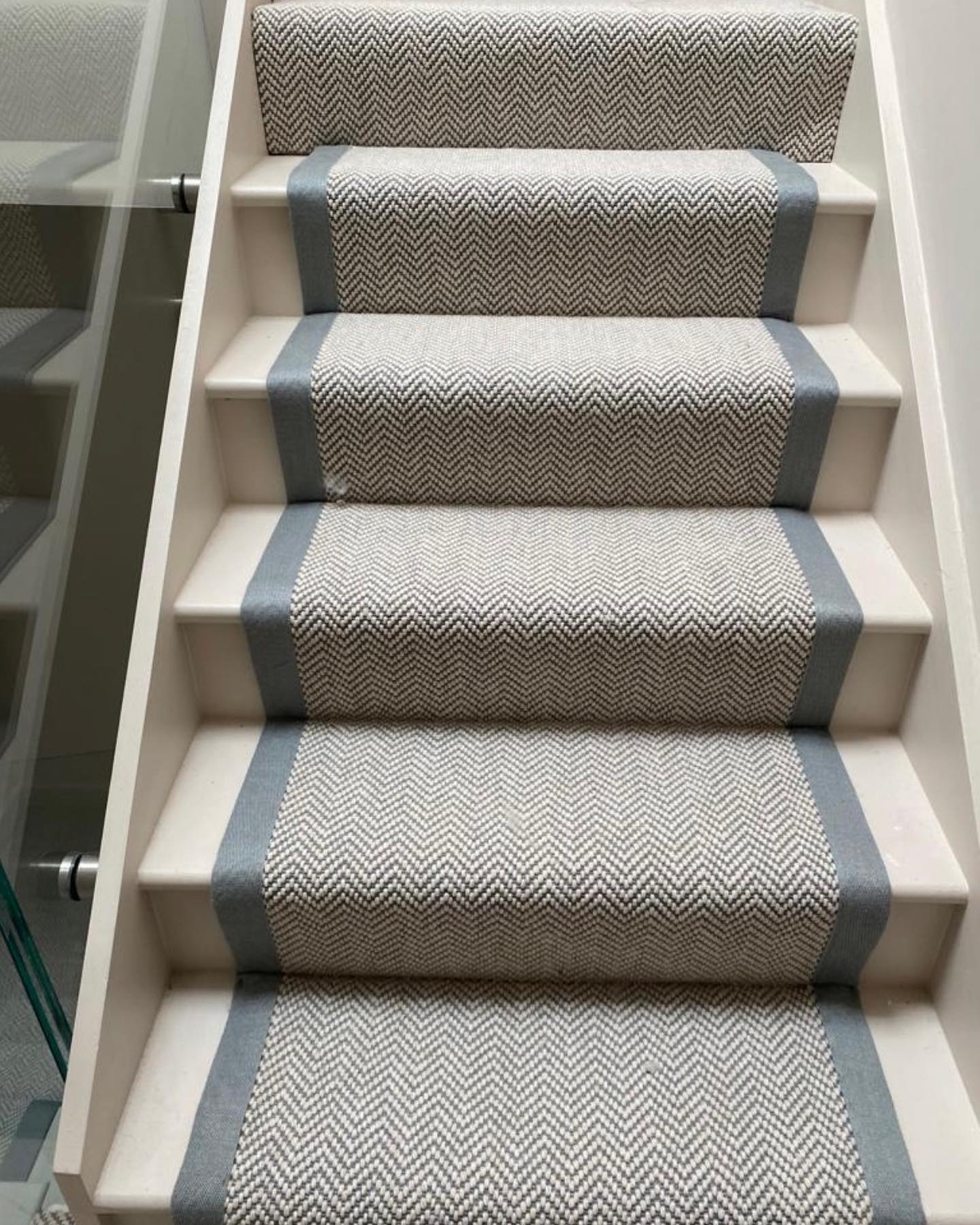 Flat Weave Herringbone carpet laid to living areas in a Hampstead home and then edged with contrasting linen tape to create a stunning, matching stair runner