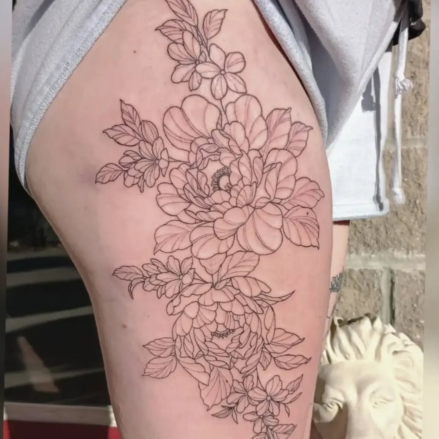 Steph lines this giant floral thigh tattoo the other day , shading to come
