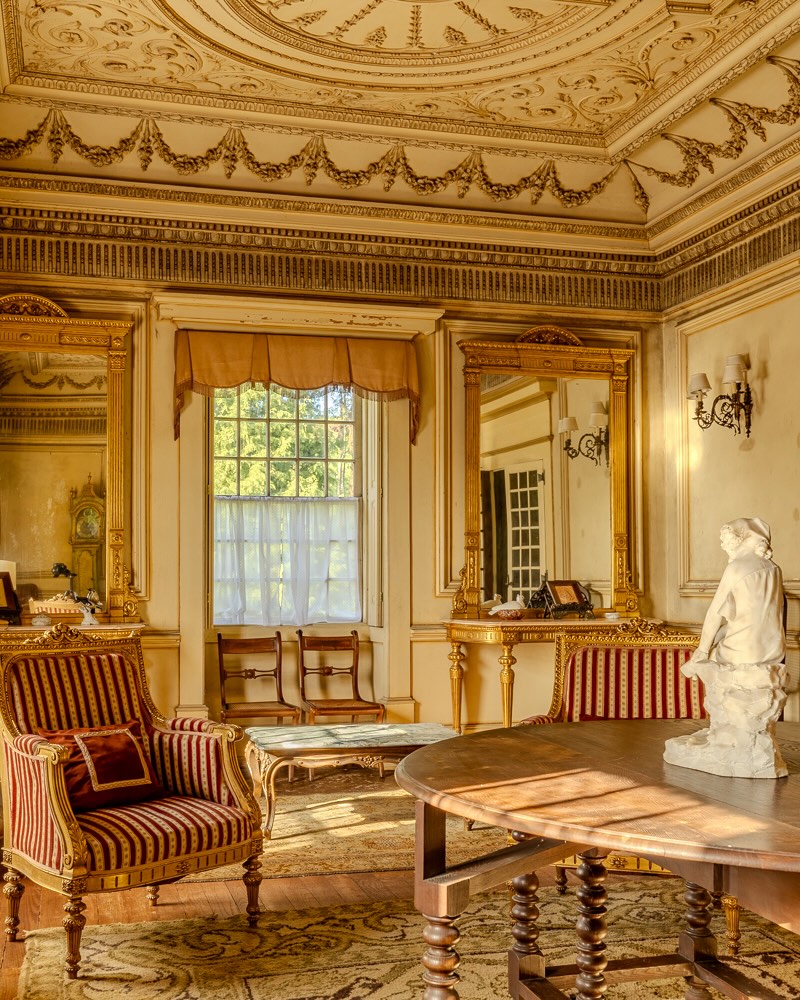The main residence carries the cadence of early twentieth century design, with frescoed ceilings, hand-painted tiles and high, dignified proportions that define its presence. Arriving through mature grounds, the estate reveals itself gradually, offering privacy and scale without excess. It is heritage anchored in land.
The principal house is arranged over two floors, with nine bedrooms and five bathrooms unfolding through a sequence of reception rooms, salons and more intimate quarters. Fireplaces ground the interiors in winter, while terraces and a cloister-like courtyard introduce a quieter, contemplative dimension.
Beyond the main residence, a secondary house of approximately 200 sqm and a separate staff house extend the estate’s flexibility, creating scope for guests, multi-generational living or a discreet hospitality vision.