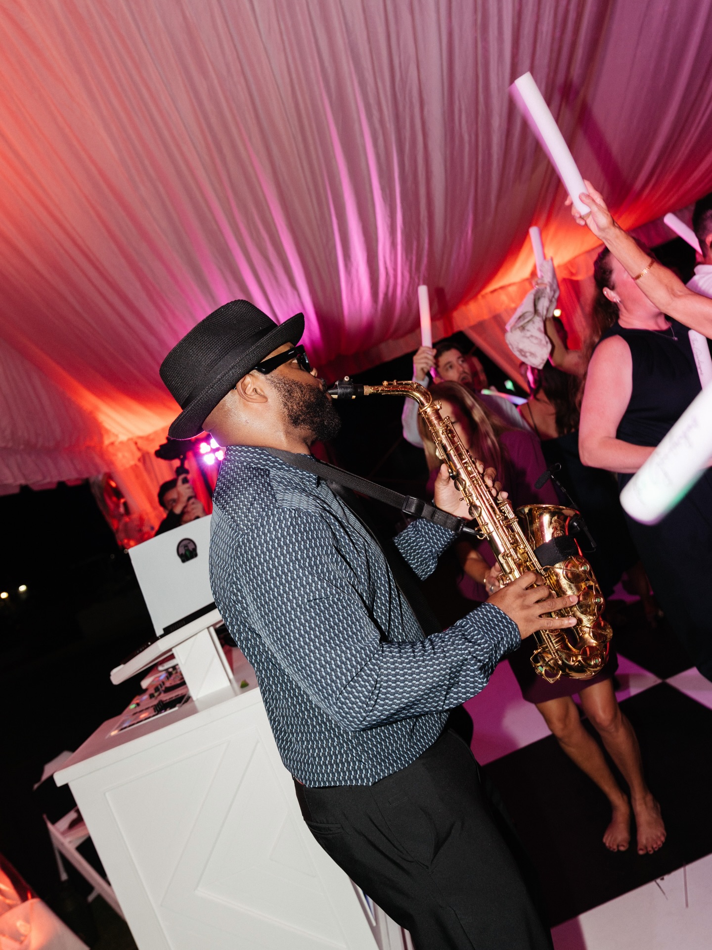 Ezra is both your DJ and your saxophonist. Using custom-mixed music, he moves seamlessly from behind the decks to the dance floor — saxophone in hand, playing live over the mix, engaging your guests in a way that no playlist ever could.