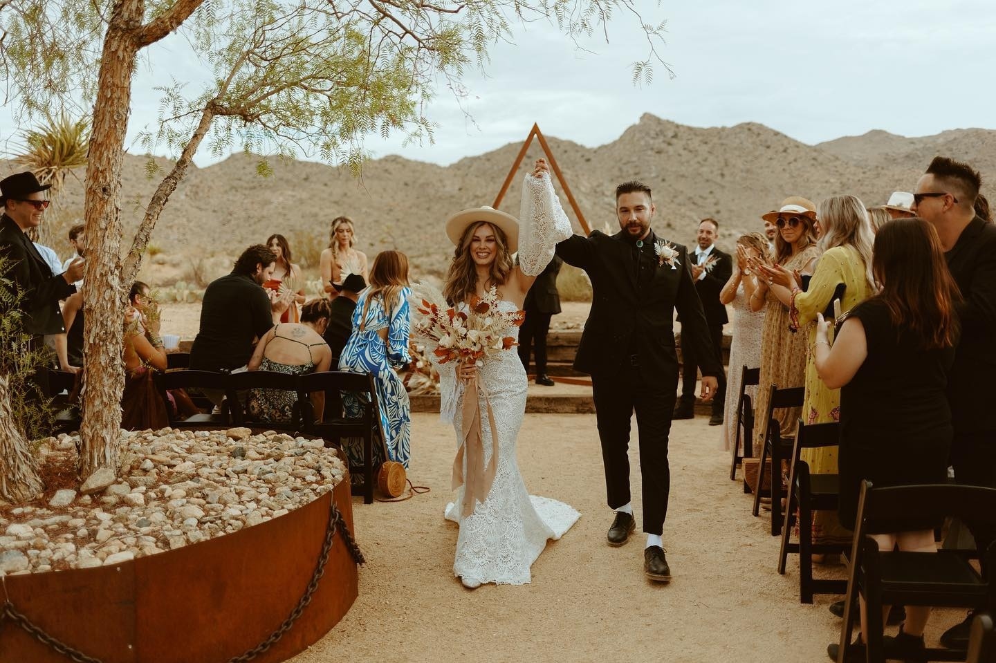 Congratulations to Kayla and Mike on so many fronts! Not only did they pull off a fantastic wedding, but we even saw our first wedding/gender reveal combo. This is why we do it! LOVE and FAMILY.
•
•
•
Photo: @goldenvibesphoto
Video: @houseofhopefilms
Venue: @sacredsandsjoshuatree
Dress: from blissbridalwear and alterations and custom sleeves by @handmadebyyamileth
Florals/Planning: @arelieventdesign
Catering: @wheatandfire
Rentals: @sigpartyrentals and @paloverdeparties
•
•
•
#SacredSands #SacredSandsJoshuaTree #JoshuaTree #JoshuaTreeCalifornia #DesertVibes #DesertLife #joshuatreewedding #bohodecor #joshuatreebride #joshuatreehotel #joshuatreeairbnb #weddingdetails #desertwedding #joshuatreevibes #joshuatreestyle #bohowedding #bohemianwedding #rusticwedding #FallWedding #weddingday #weddingwire #theknot #destinationwedding #weddingreception #weddingstyle #intimatewedding #instawedding #weddinginspiration
#weddinginspo #genderreveal 