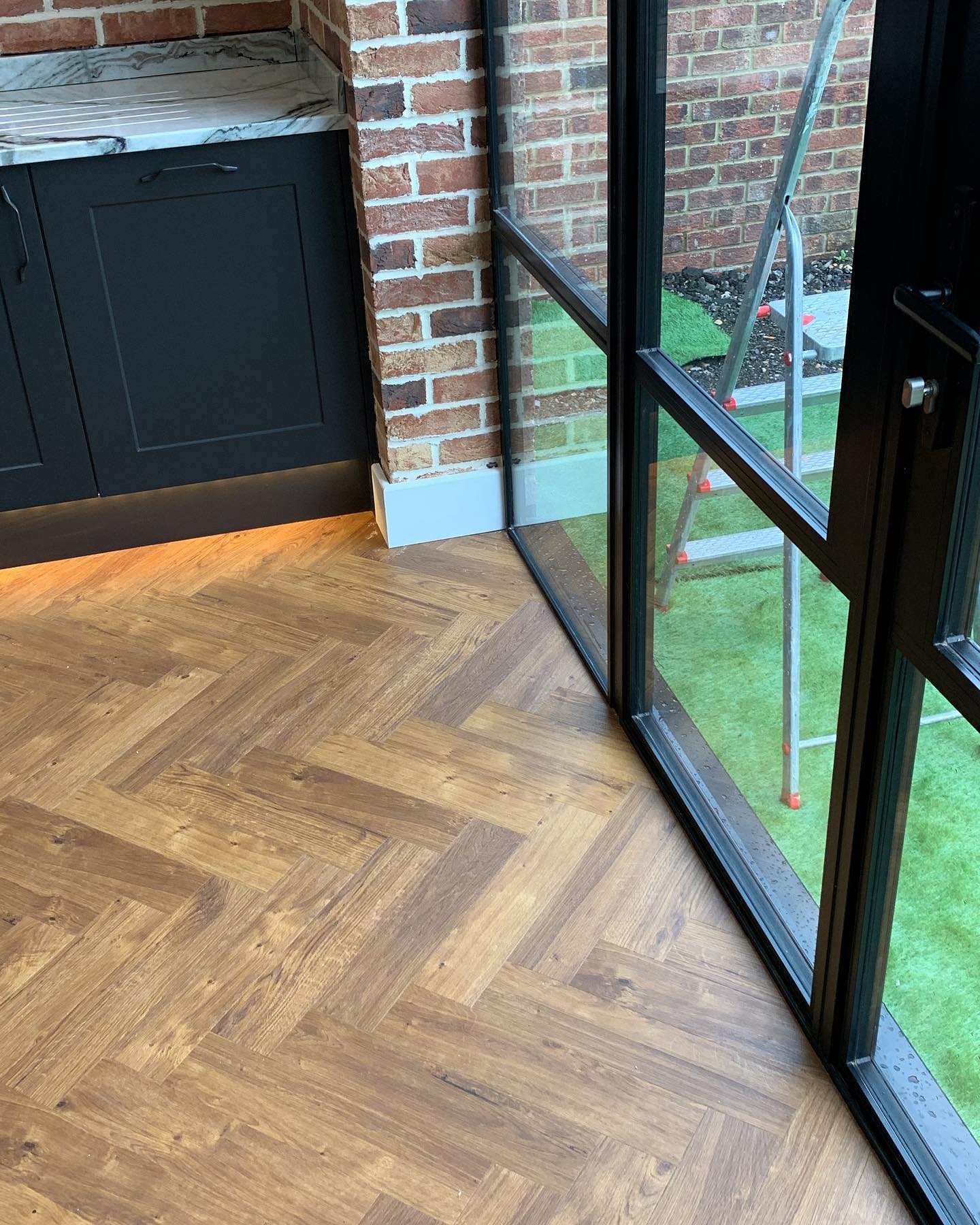 Quartzite worktops black ally crittle style doors, herringbone amtico flooring really works well