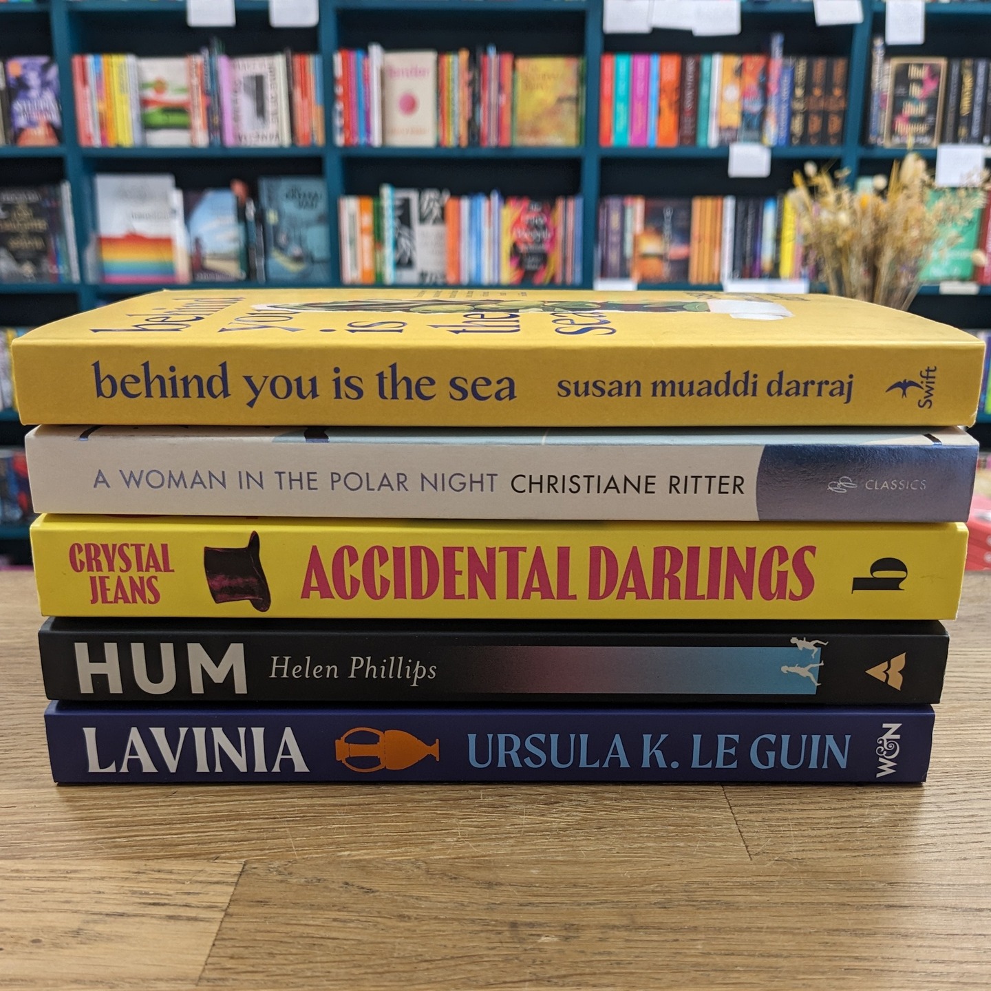 Our Tuesday Book Club has read some bangers in the past few months! While never fully unanimous, the majority of the group has loved these titles:
- Behind You is the Sea by Susan Muaddi Darraj
A mosaic novel following members of a Christian Palestinian community in the United States. Despite heavy themes and characters experiencing some of life's most difficult moments, there is a lightness that buoys you on.
- A Woman in the Polar Night by Christiane Ritter
Gorgeous landscape descriptions juxtaposed with the practicalities of three people overwintering in a tiny hut in the polar north. A classic memoir about the year the author spent on Svalbard with her husband, who was living there as a trapper.
- Accidental Darlings by Crystal Jeans
A mystery underpins this historical fiction about a young orphan who goes to live with her eccentric aunt at her small country manor. Gothic vibes, lovable characters, and queer themes throughout make for a very fun read.
- Hum by Helen Phillips
Speculative fiction set in a city full of super-intelligent robots, constant surveillance, and rampant device addiction. A mother provides a nature retreat for her family, but things go terribly wrong.
- Lavinia by Ursula K. Le Guin
Inspired by Book 7 of the Aeneid, this is a feminist telling of young Lavinia, who is determined to follow her prophesied destiny to marry a Trojan hero. The poet as the prophet is a clever device that gives this myth a modern self-awareness.
#bookrecommendations #bookrecs #bristolbookclub #bristolbookshop #bs5 #bookshop #indiebookshop #bristolbookstagrammers #bookstagramuk #shoplocal