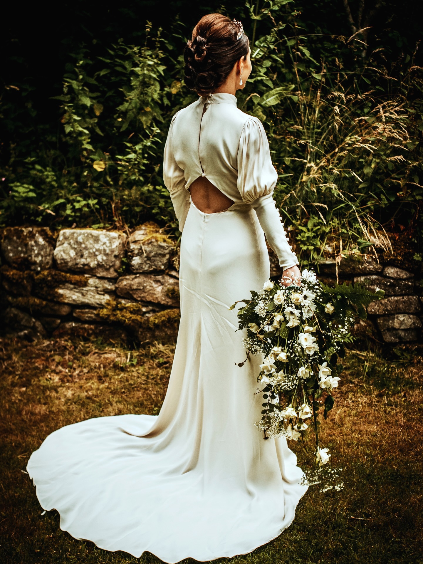 This dress is pure elegance. From the soft, flowing silhouette to the delicate open-back detail and long sleeves, every part of it feels timeless and effortlessly beautiful. Paired with wild, cascading florals, the whole look is romantic, graceful, and perfectly at home in the woods. 🤍🌿 Capturing details like this — the movement of the fabric, the texture, the quiet in-between moments — is what I love most about my wedding photography. Telling the story of a day through style, atmosphere, and the little things that make it unforgettable.
We’re a little obsessed with this bridal style.
#TimelessWeddingstyle #NatureInspiredWedding #Scotlandweddingphotographer #aberdeenweddingphotographer #rusticweddings
See more at babeinthewood.com/weddings