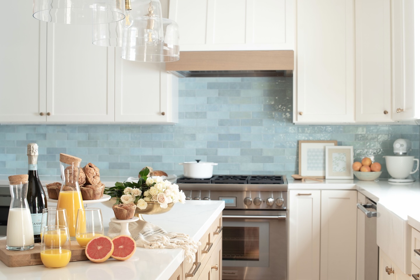The perfect pop of color! 👌🏼 🤍 Our client wasn’t afraid to bring a little blue into her kitchen! We paired a creamy white cabinet with a soft blue backsplash. The variation and movement in the backsplash paired with creamy white cabinetry bring depth, character and a timeless look to her kitchen!