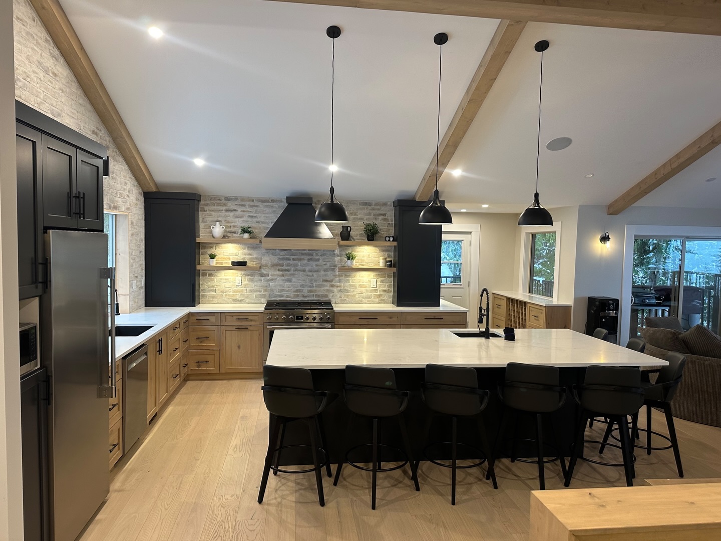 Part of a full lake house renovation, this kitchen was redesigned to create a brighter, more open gathering space.
Featuring vaulted ceilings with exposed beams, a large central island, custom cabinetry, and a stone and mortar backsplash. #ironrosehomes