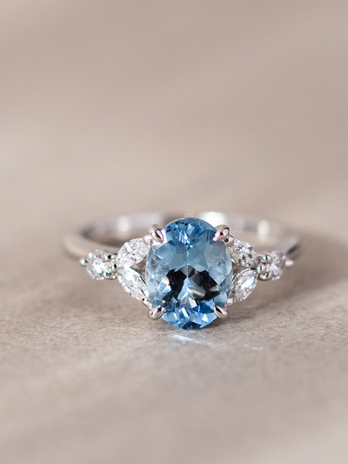 A quiet bloom, captured in light.
Our Feuille Ring brings together the serene blue of aquamarine — reminiscent of clear spring skies — with marquise-cut diamonds that gently frame it like delicate leaves. At its heart, the aquamarine rests like a single flower in bloom, soft yet luminous, accompanied by glimmers of light that echo the grace of nature.
Refined yet poetic, a piece that feels like wearing a fleeting moment of spring.
Available at our Takashimaya counter—visit us to experience the piece in person.