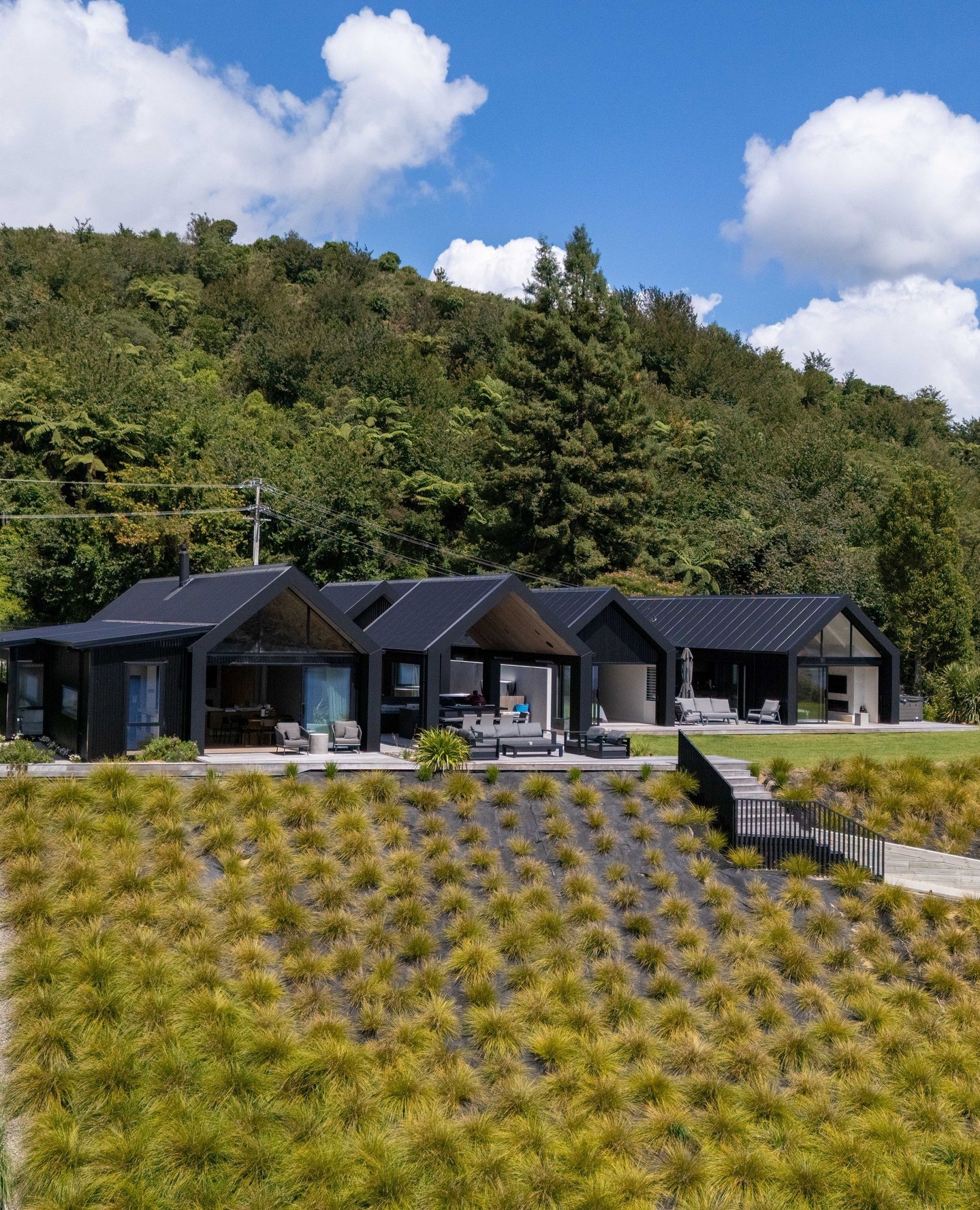 Set quietly into the hills above Lake Rotoiti, these twin lakehouses in Okawa Bay are a study in balance — architecture, landscape and craftsmanship working as one.
Positioned right on the water’s edge, the build called for considered planning at every stage. From recontouring the land and stabilising the slopes, to restoring the lakefront and delivering a new jetty and boat shed, every detail was carefully resolved. Delivered in collaboration with Rotorua District Council, Bay of Plenty Regional Council and Te Arawa Lakes Trust, this is a project we’re immensely proud to have brought to life.
The architectural language draws from the humble lakefront boat shed — reimagined through a refined lens. Corrugated iron, simplicity of form, and a connection to place — elevated into a home that sits effortlessly within its environment.
#CalleyHomes #ArchitecturalLiving #LakeRotoiti #OkawaBay #NZArchitecture #CoastalLiving #Craftsmanship #DesignInspiration
