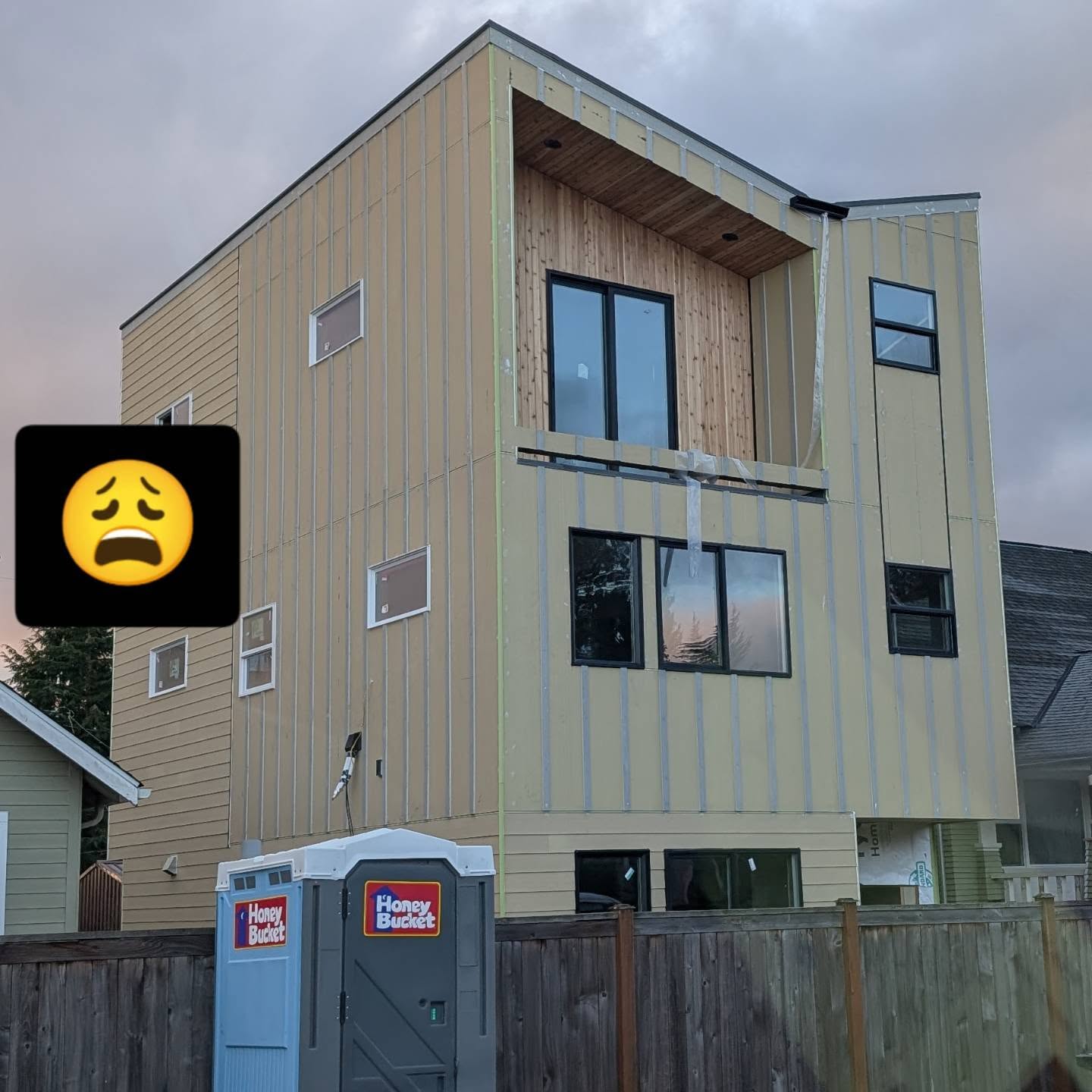 "I have an idea - let's take the 2 most inherent benefits of a roof (1. water drips off of it onto the ground, 2. it extends over the walls and protects them) and throw them in the garbage!!"
Sigh. Just drove by this site in my neighborhood. C'mon people! It doesn't even look good.