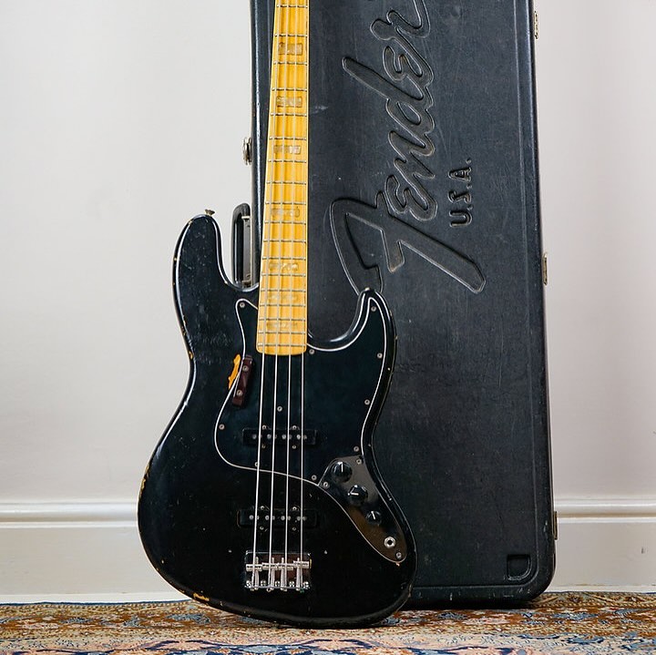 1975 Fender Jazz Bass.
Black over factory Sunburst (swipe to see it peeping through)
Pearl blocks may not be for everyone - but I like this one!