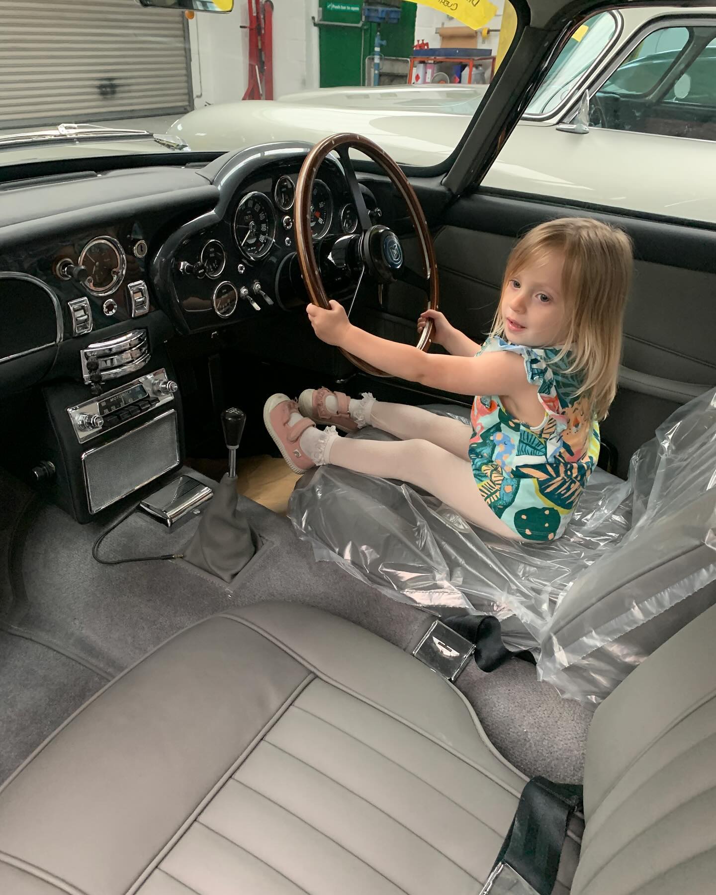 Our little visitor just couldn’t choose her favourite! #choices #AstonMartin #classicastonmartin #DB4 #DB5