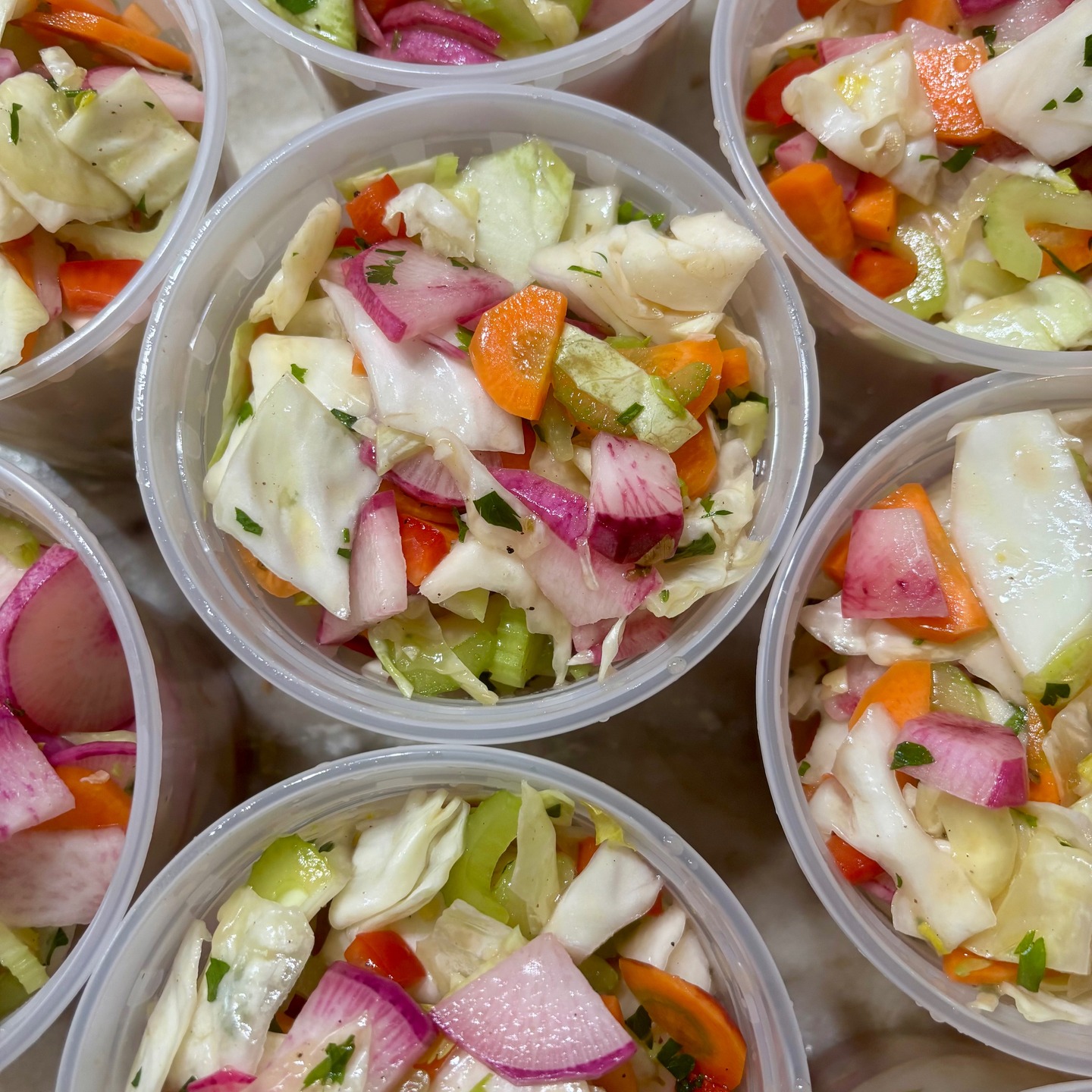 My Crunchy Seasonal Salad currently features purple daikon, carrots, celery, cabbage, bell pepper, and parsley. Its almost-pickle-tasting bright and tangy dressing keeps it crispy for up to a week.