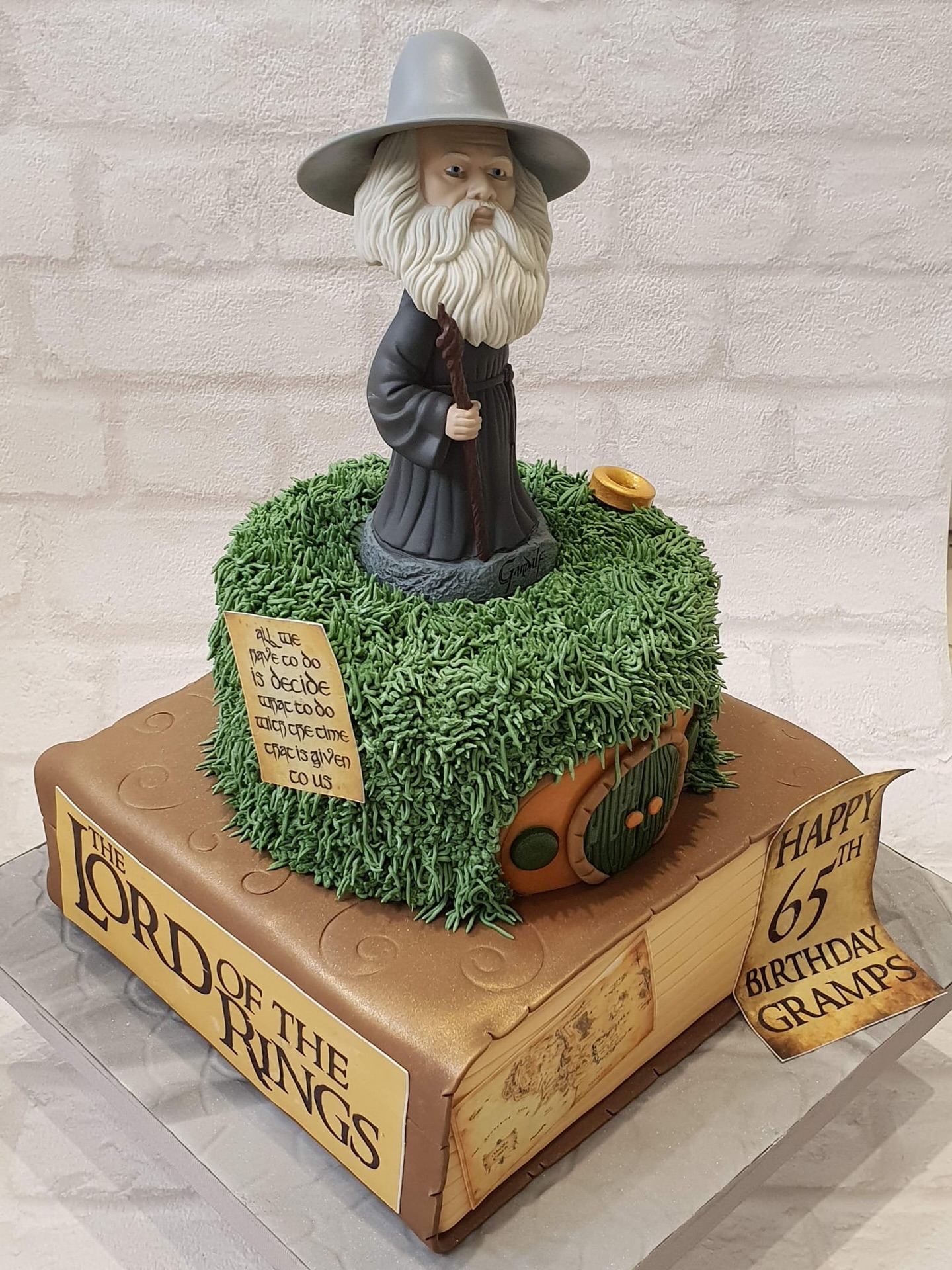 “All we have to decide is what to do with the time that is given to us…” ✨
A truly magical cake inspired by The Lord of the Rings, featuring a Gandalf standing proudly on the cake of a cosy hobbit hole scene 🧙♂️🌿 Every detail, from the textured grass to the iconic book base, brings a little piece of Middle-earth to life.
Created to celebrate a very special milestone birthday 🎉
And with 2026 marking 25 years since The Lord of the Rings: The Fellowship of the Ring first graced our screens, plus the extended editions returning to cinemas this January… there’s never been a better time to relive the adventure 💍🎬
#LordOfTheRings #Gandalf #LOTR #birthdaycake @ianmckellen