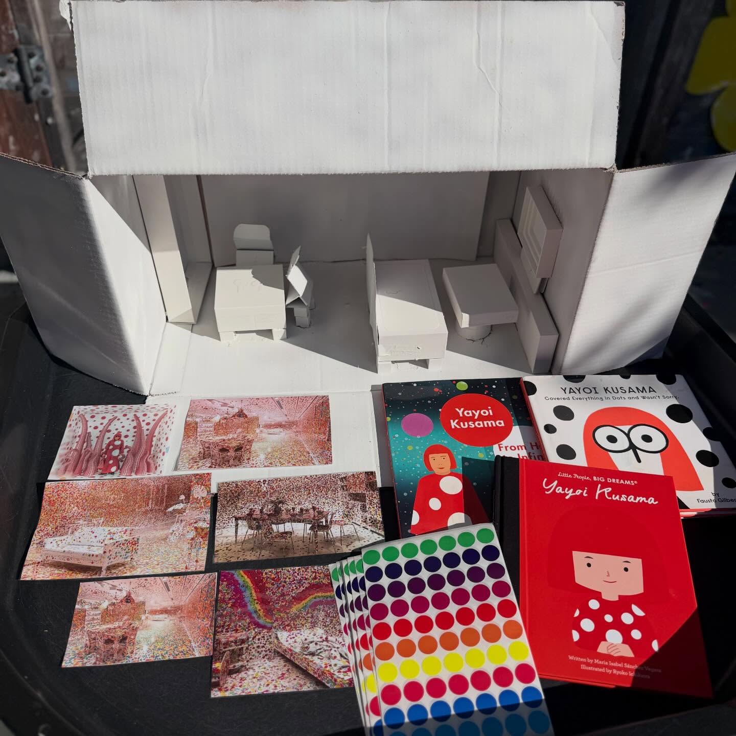 Inviting Children to Explore Yayoi Kusama’s Obliteration// As part of exploring influential women in art, we introduced the children to #YayoiKusama, a groundbreaking artist known around the world for her bold use of color, repetition, & her iconic polka dots. Kusama has spent decades creating immersive installations, paintings, & sculptures that transform everyday spaces into vibrant works of art. Her work often explores the idea that small repeated elements like dots can grow & spread until they completely transform an object or environment.
One of her most famous interactive installations is The #obliterationroom. In this installation, an entirely white room filled with white furniture is slowly covered with colorful dot stickers by visitors. Over time, the once blank space becomes completely “obliterated” with dots, turning the room into a collaborative & ever-changing artwork. The installation invites people of all ages to participate & become part of the creative process.
Inspired by this idea, we invited the children to create their own miniature version of Kusama’s concept. We began by providing 3-D box structures made from recycled packaging materials, which were spray painted white to resemble the blank space of the room. The children were then invited to transform the boxes by placing colorful dot stickers all over them. As they worked, the simple white boxes slowly became vibrant & playful sculptures filled with pattern & color.
This experience supports many important developmental skills. Placing small stickers strengthens fine motor control & hand-eye coordination, while repeating dots encourages pattern recognition & early mathematical thinking. Working with recycled materials also introduces children to creative reuse, showing them that everyday objects can be transformed into art. Most importantly, this type of open-ended experience encourages children to experiment, collaborate, & see themselves as active participants in the creative process, just like visitors contributing to Kusama’s Obliteration Room. #tinkerwonderplay #arteducationmatters #preschoolart