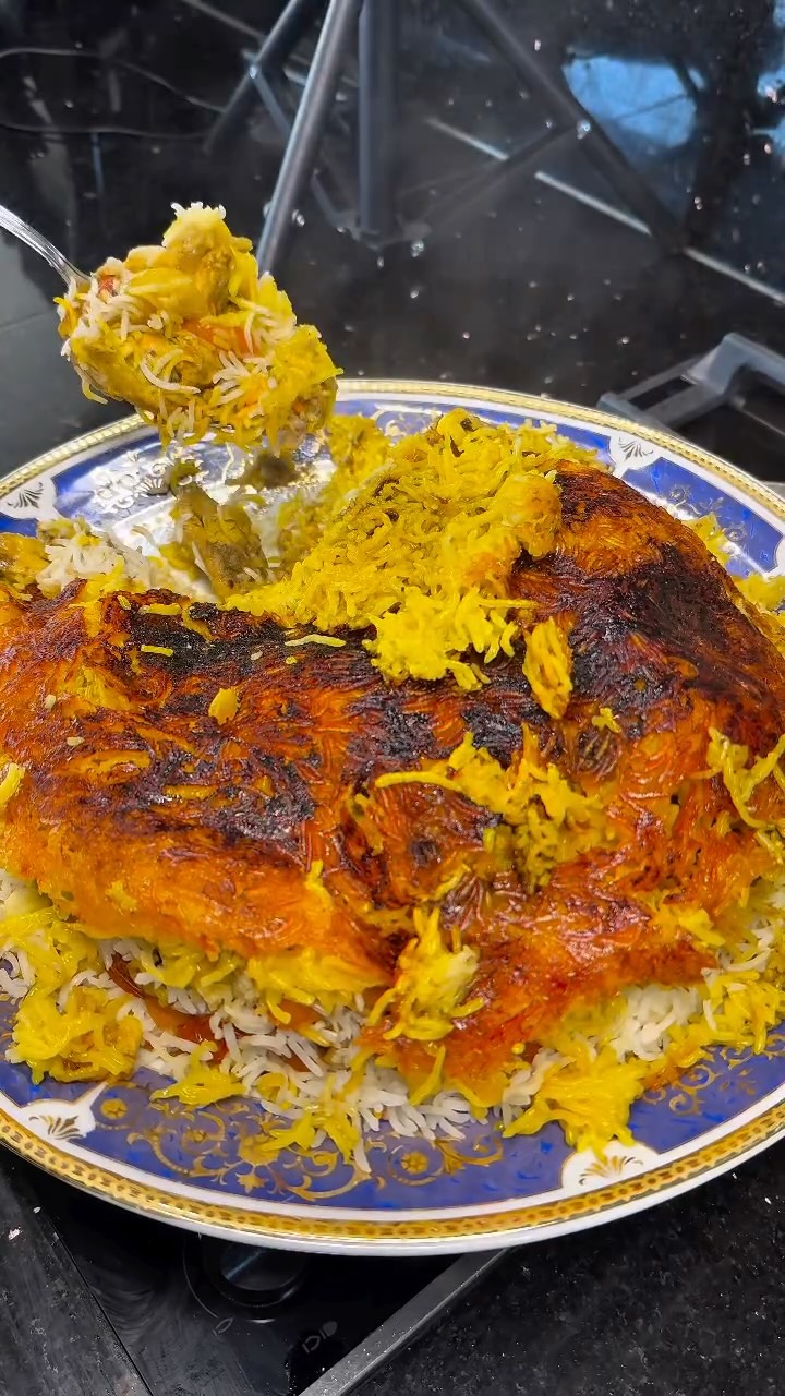 Joojeh Polo ⬇️⬇️⬇️
RECIPE BELOW (Saffron Chicken Rice with sumac)
Ingredients
Chicken Marinade
• 1 kilo chicken thigh, cut into cubes
• Juice of 2 lemons
• 2 medium onions, thinly sliced
• 1½ teaspoons salt
• 1 teaspoon turmeric
• Saffron water (1 g saffron bloomed )
Rice
• 400 g basmati rice
• 1½ teaspoons salt
• 500 g cherry tomatoes
• 4 tablespoons oil, divided
• Saffron water (1 g saffron bloomed )
• 2 tablespoons sumac
Method
In a large bowl, mix lemon juice, saffron water, salt, and turmeric.
Add chicken cubes and mix well.
Add sliced onions and gently combine.
Cover and refrigerate at least 6 hours, preferably overnight.
Heat a pan or grill pan over medium-high heat.
Grill chicken cubes until lightly charred and just cooked through. Remove and set aside.
In the same pan, grill the marinated onions until soft and golden.
Add cherry tomatoes and cook for 5–7 minutes, until they blister and release juices. Set aside.
Wash the basmati rice until water runs clear.
Cook 2 tablespoons oil and salt until rice is parboiled (grains soft on the outside but firm inside, about 6–7 minutes).Drain and set aside.
In a wide pot, heat 2 tablespoons oil over medium heat.
Add half of the saffron water.
Layer half of the rice evenly in the pot.Sprinkle 1 tablespoon sumac over the rice.
Add grilled chicken, onions, and tomatoes evenly.Sprinkle remaining 1 tablespoon sumac.
Cover with the remaining rice.
Drizzle the rest of the saffron water on top.
Wrap the lid with a clean kitchen towel, cover the pot, and cook on medium-low heat for 40–45 minutes to steam and form tahdig.
#persiancuisine #persianfood #saffronchickenrice #homecooking #foodlover