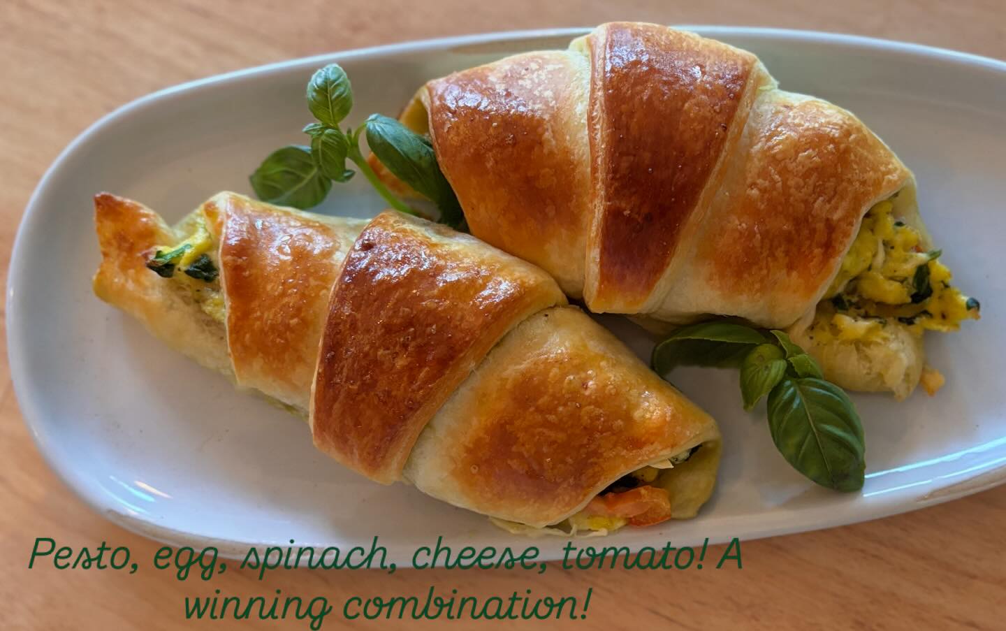 Hot croissant stuffed with egg, spinach, cheese, pesto and tomato! Come get em while they are hot!