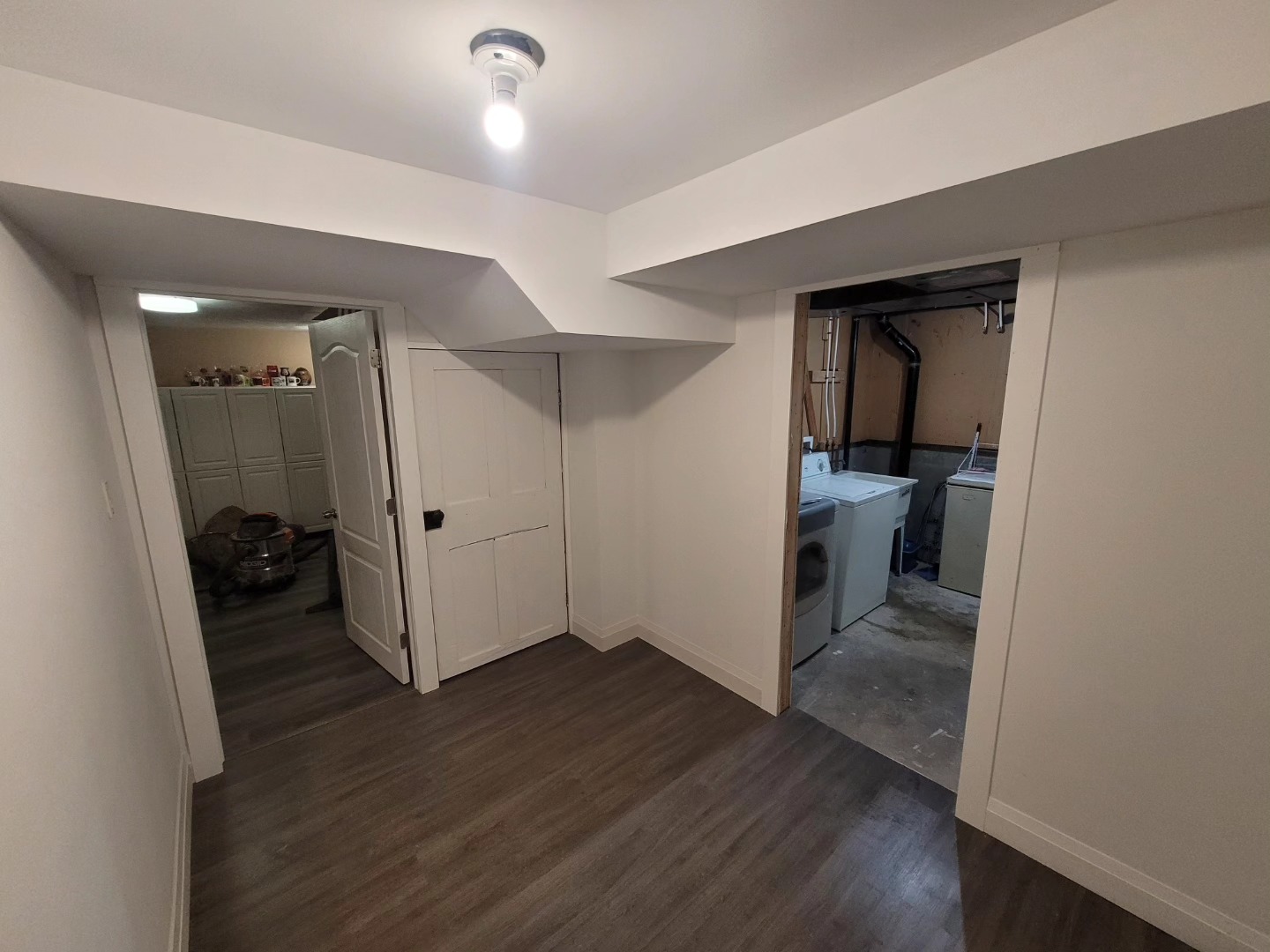Basement finishing by Maximus Craftsmanship to add an office space, laundry room, and storage area with some shelving. Swipe to deconstruct. 2 walls were added.