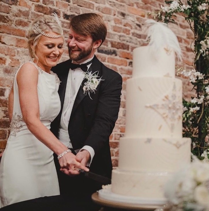 It’s hard to believe it has been over a year since this roaring 20’s wedding! All buttercream design with hand poured and painted sugar gems. #happyanniversary #weddingcake #southernweddings #roaring20swedding